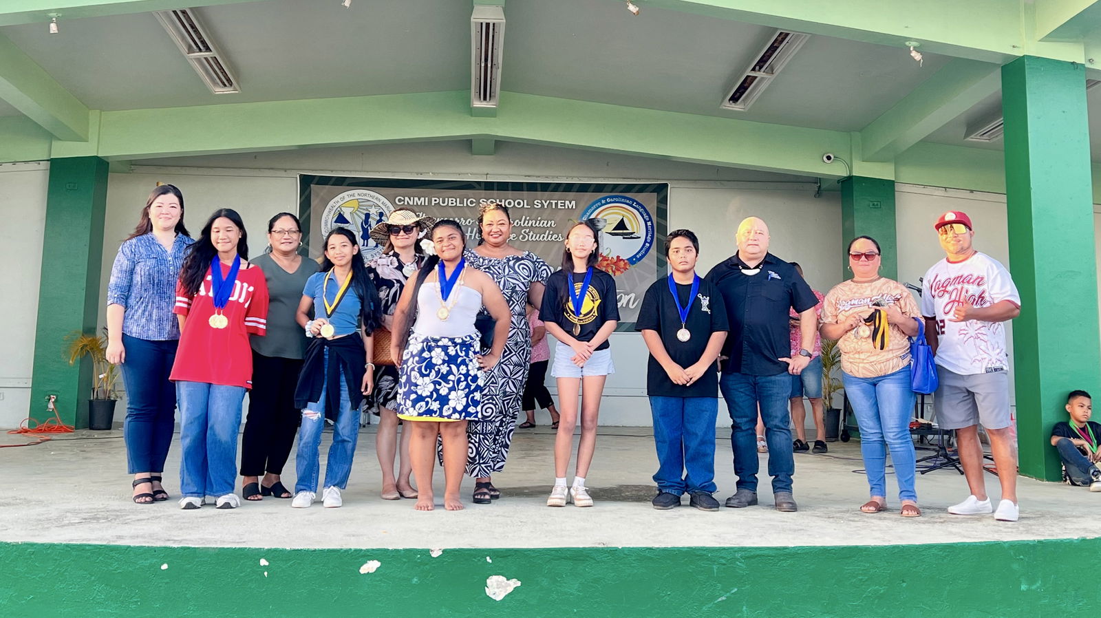 The middle school poster/drawing category winners are presented on stage.