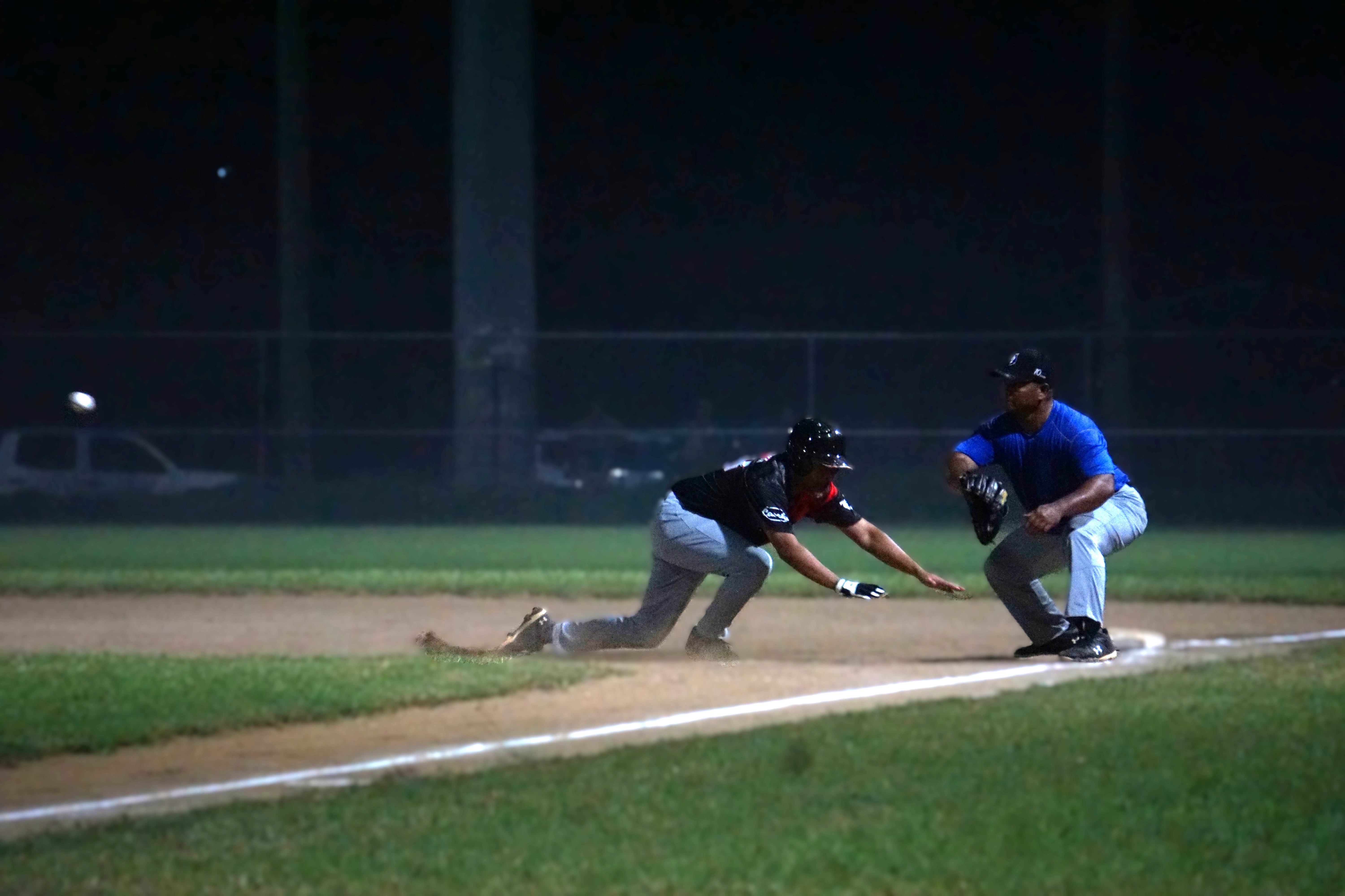 The Falcons’ Andave Camacho slides to first base to avoid a pickoff during a game against the Blue Jays in the 2024 SBL Masters League at Francisco “Tan Ko” Palacios Baseball Field.