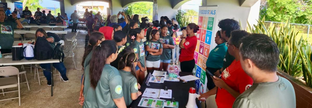 School MY WAVE Club members learn from an exhibitor from Northern Marianas College during the Marianas Tourism Education Council Tourism Summit on Jan. 24, 2025, at Garapan Central Park in Saipan.