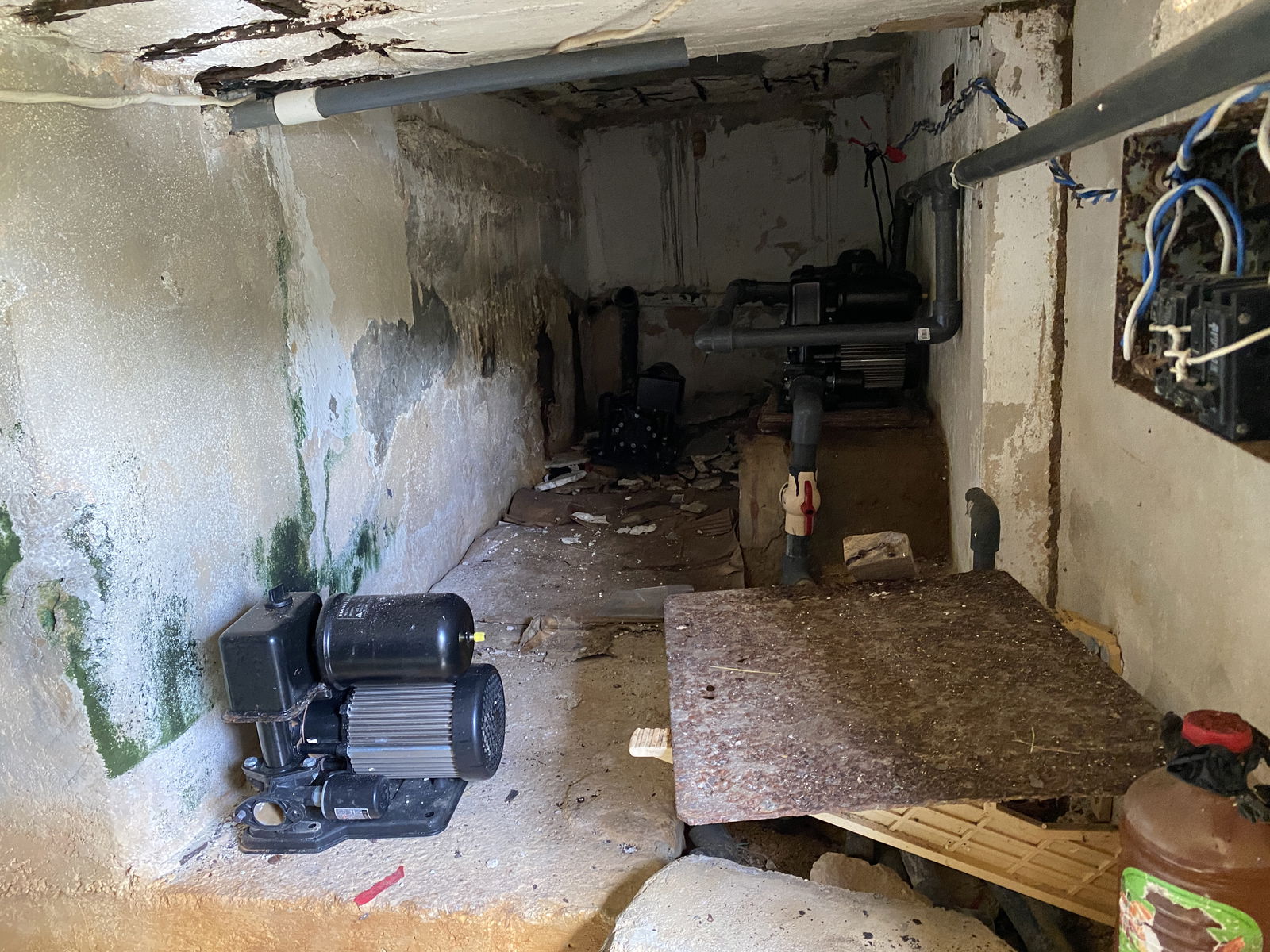 A water pump, right, is connected to pipes at the CIC building. Nearby, are two other unused water pumps.