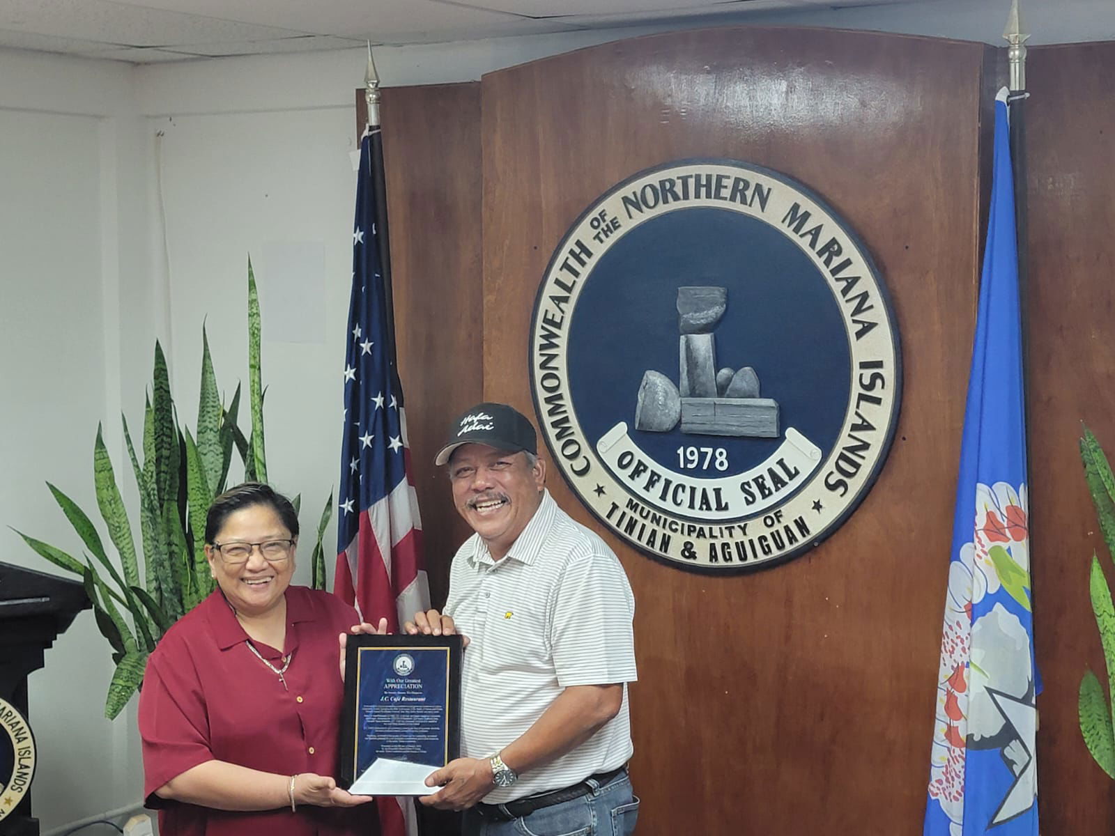 Tinian Mayor Edwin P. Aldan, right, hands a plaque of appreciation to J.C. Cafe manager Marie Rose “Lot” Bunao.