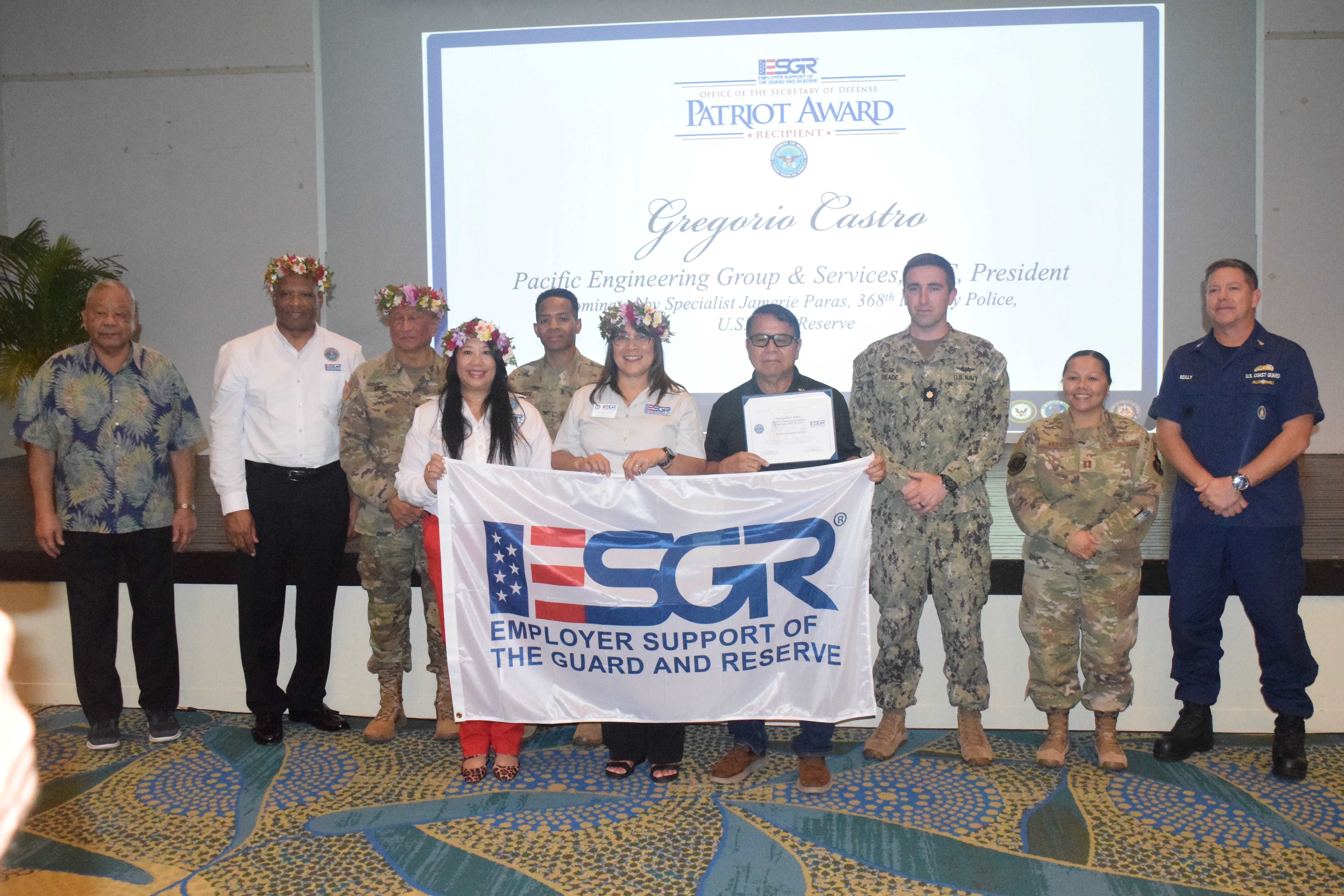 Pacific Engineering Group & Services, LLC President Gregorio Castro holds his Patriot Award as he poses for a photo with ESGR officials.