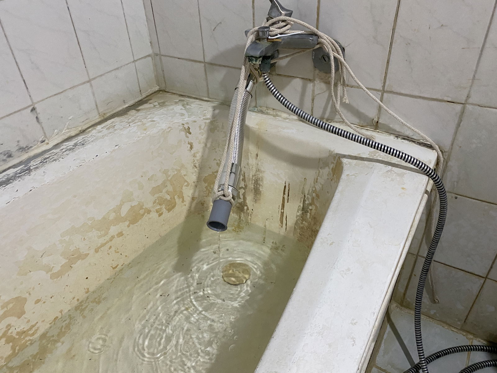 Water trickles out of this pipe in Daniel Durkin's apartment. He pools water in order to transfer it to a plastic trashcan so he can wash and flush the toilet.