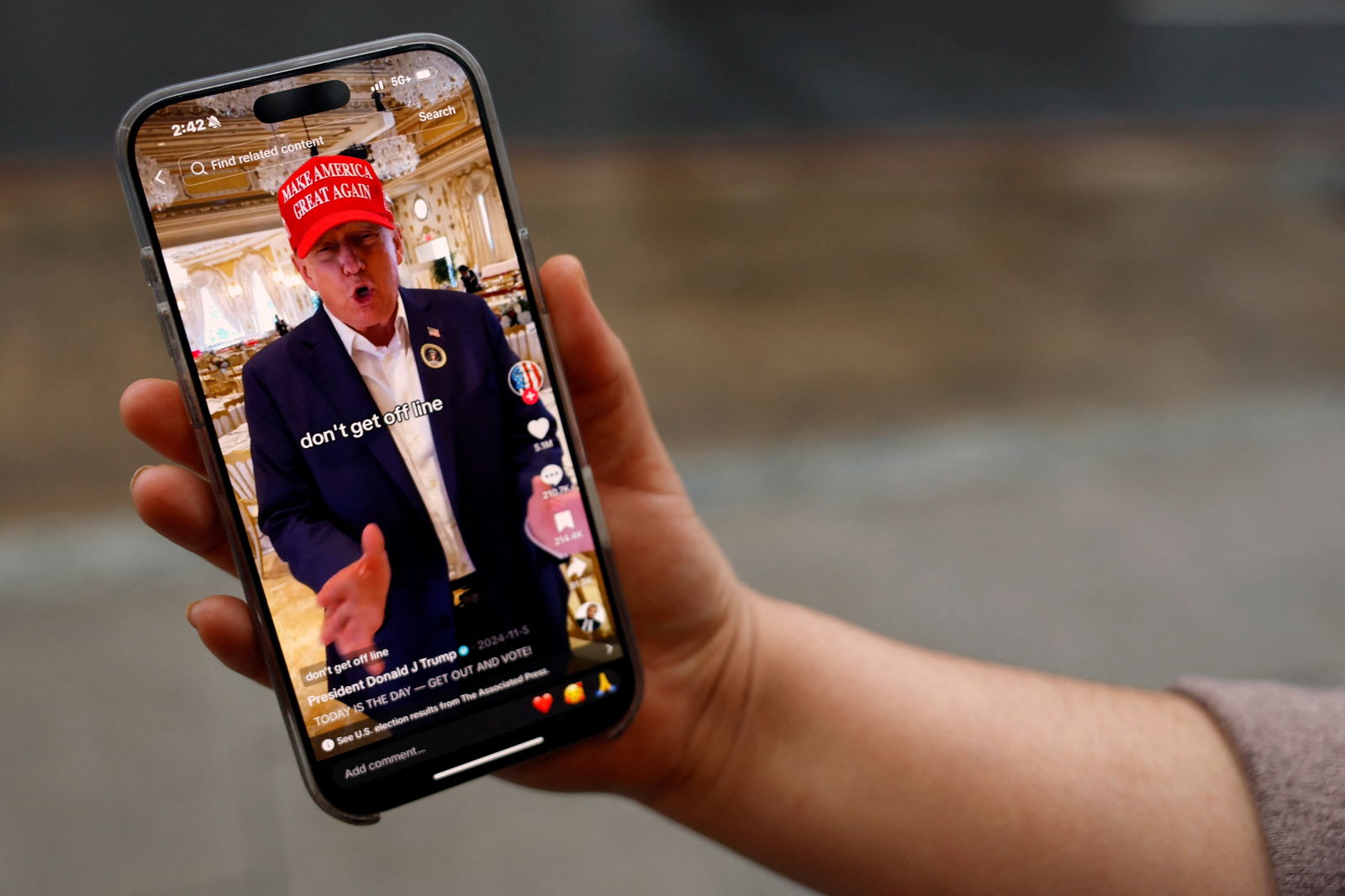 A woman poses with her smartphone displaying the @realdonaldtrump TikTok page, in Washington, D.C., Jan. 19, 2025.