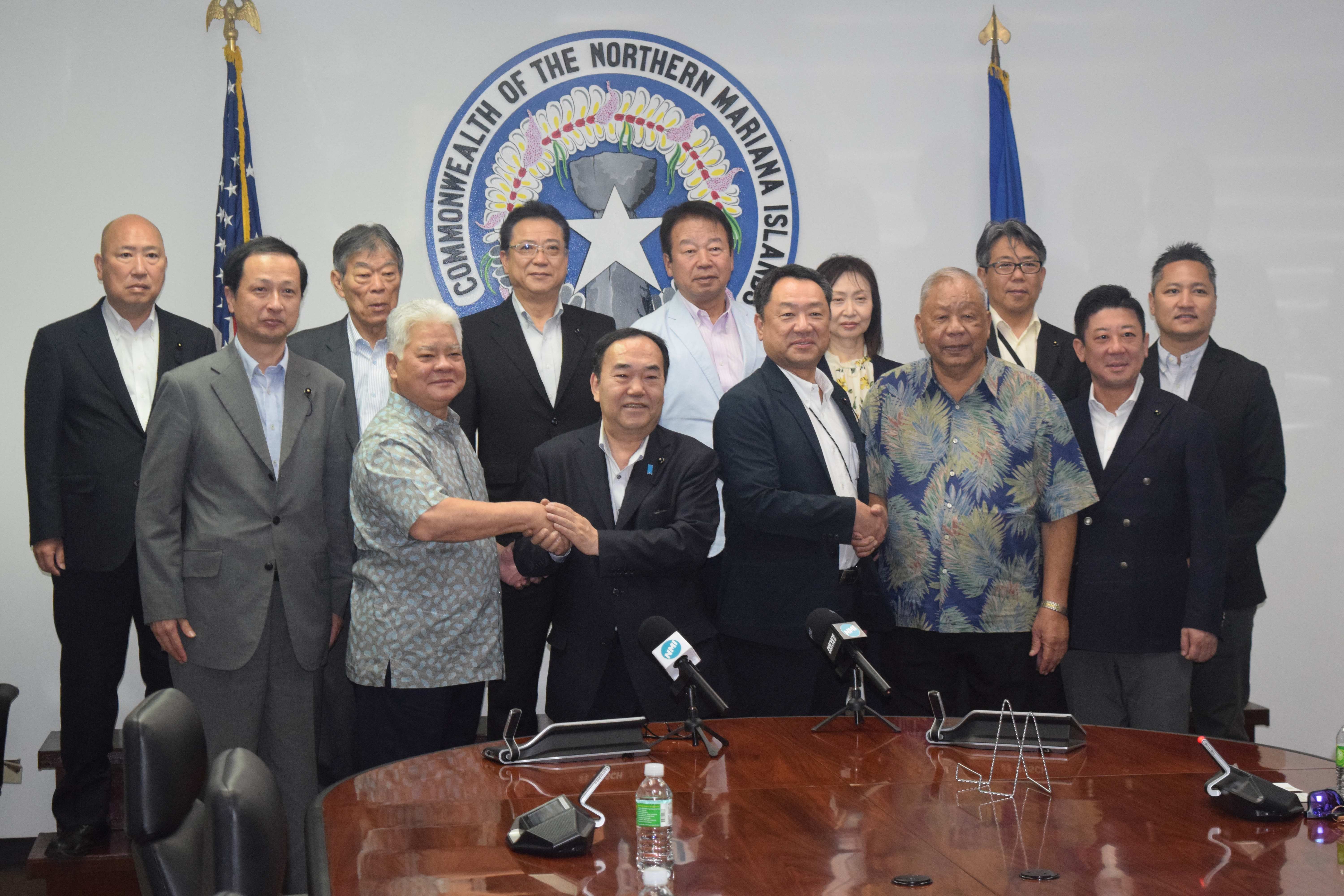 Gov. Arnold I. Palacios, second left, first row, shakes hands with Hiroshima Prefectural Assembly Chair Nakamoto Takashi, third left, while Lt. Gov. David M. Apatang shakes hands with Hayashi Daizo, the chair of the assembly’s Special Committee for International Peace, Multi-cultural Coexistence, and Promoting Investment in People, as they pose for a photo with other members of the assembly in the governor’s conference room on Friday.Photo by Emmanuel T. Erediano