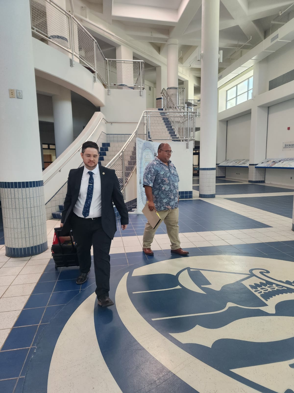 Chief Solicitor J. Robert Glass Jr., left, and House legal counsel Joe Taijeron in the lobby of the local courthouse in Susupe on Monday.