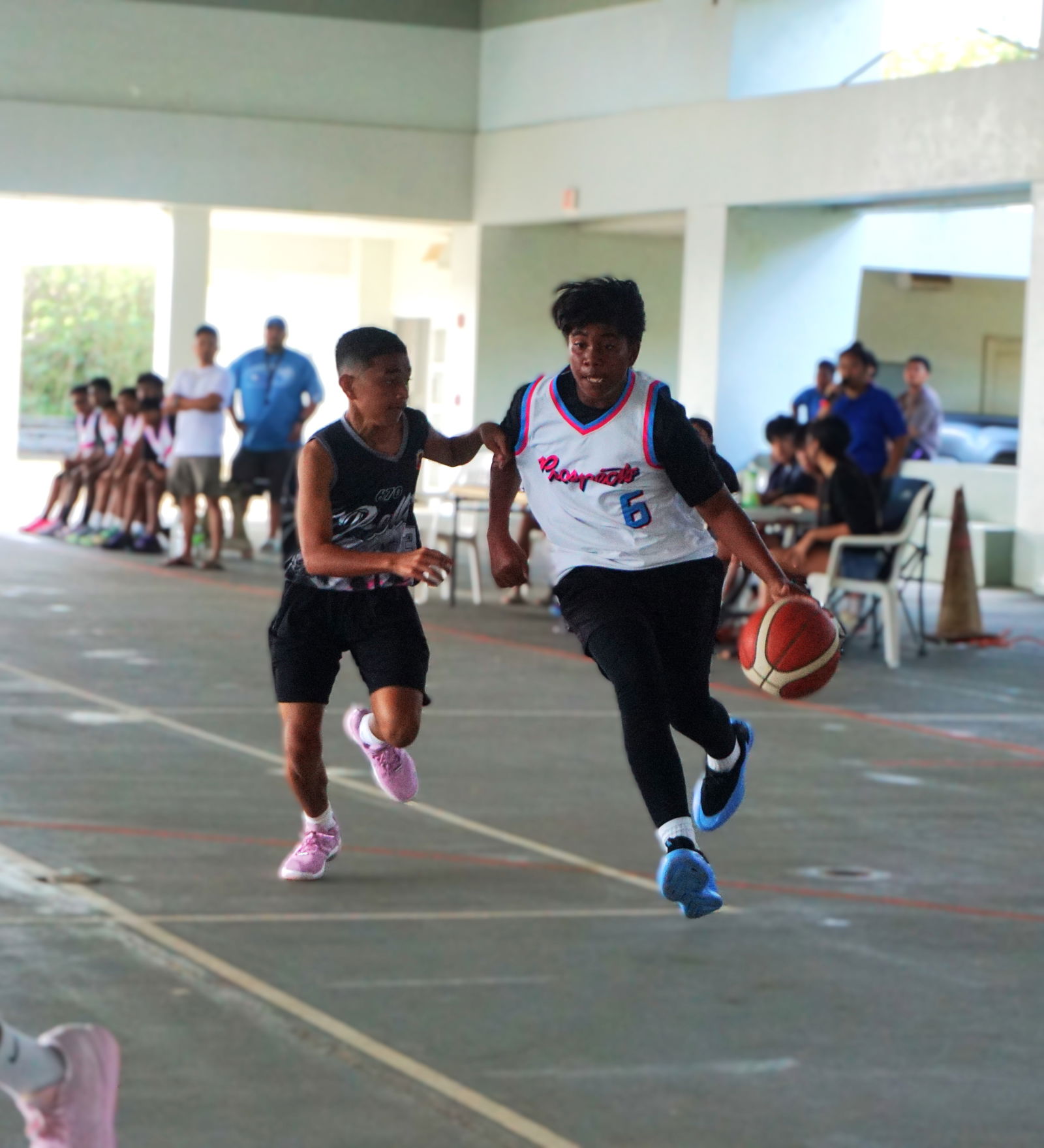 Prospect 2’s Kelvin John dribbles past a defender during an NMIBF 2025 15U Basketball League game at the Koblerville gym on Saturday.