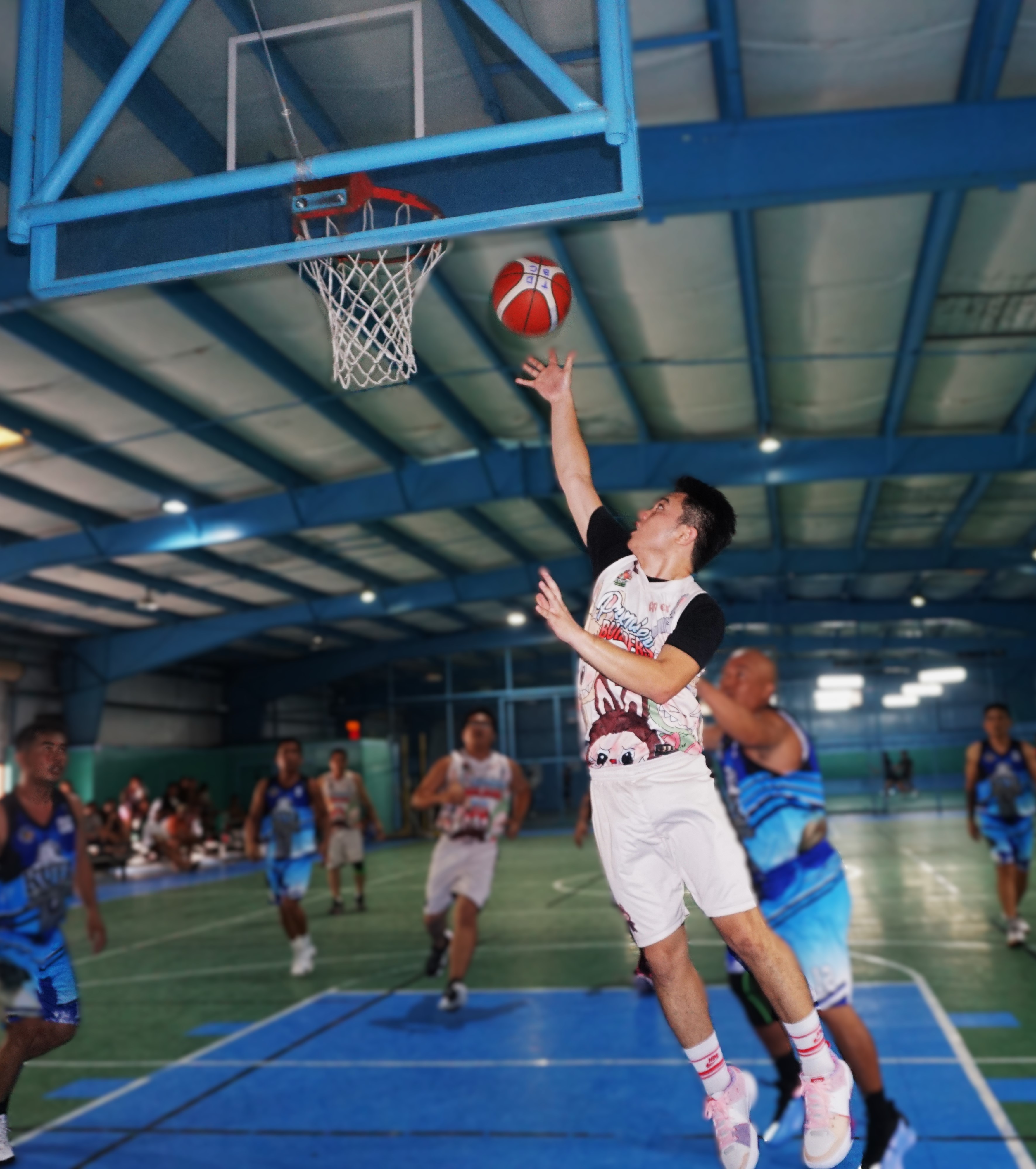 Premier Builders’ Mark Lacanilao extends for the finish during an opening game against the Eagles in the Alpha Kappa Rho 1st Semi-Open Invitational Basketball League 2025 at the TSL Sports Complex on Sunday.