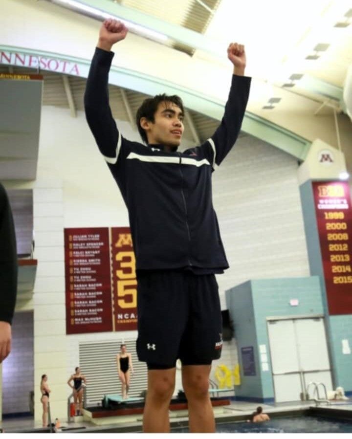 Kean Pajarillaga raises his hands after winning gold in the 200 Backstroke event of the Minnesota Intercollegiate Athletic Conference Championships at the Jean K. Freeman Aquatic Center in Minnesota last week.
