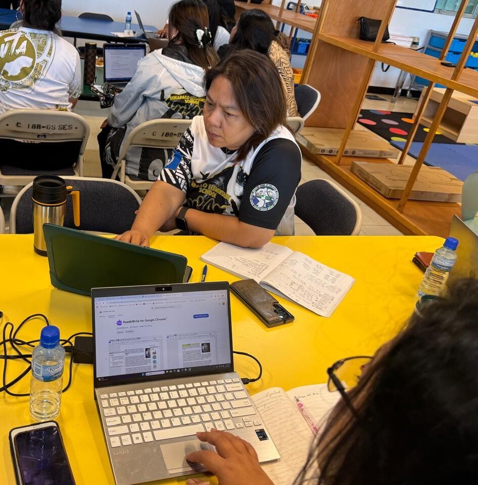 Sinapalo Elementary School teacher Jesusa Calvo logs on to her laptop to try out the new assistive tool.