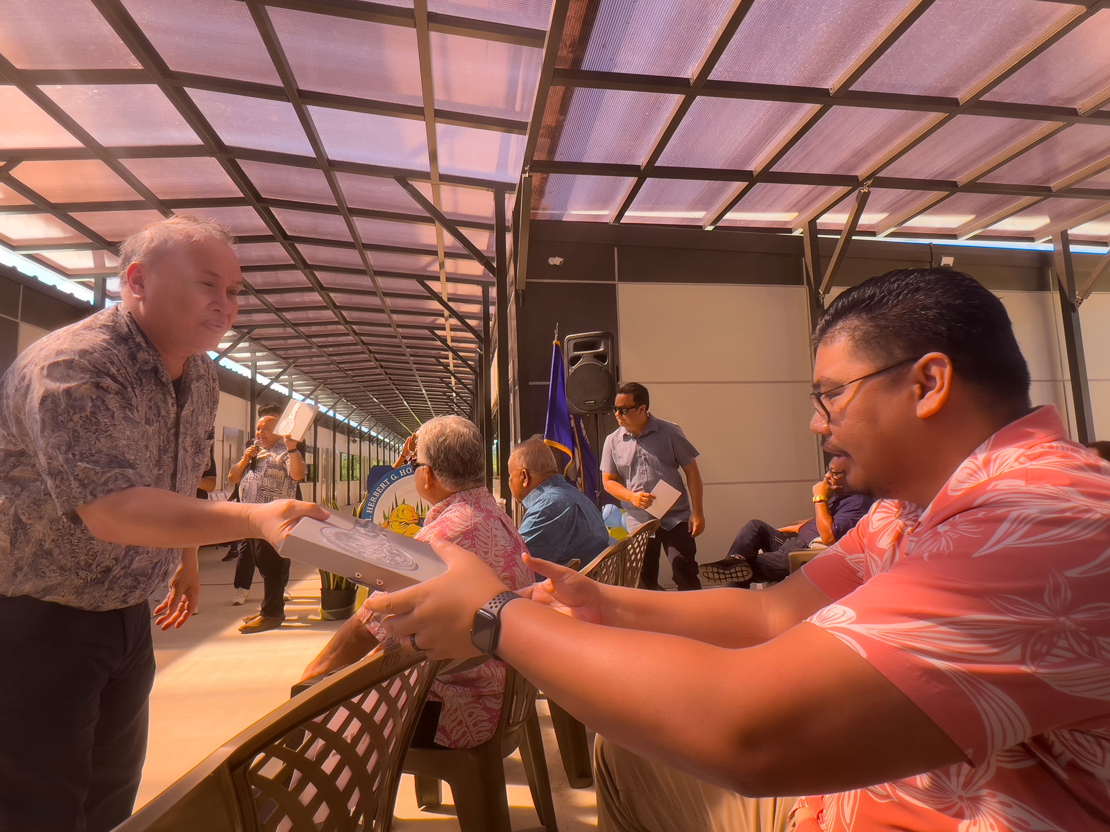 The commemorative key to the newly opened Hopwood Middle School modular classroom building is handed to BOE Secretary-Treasurer Antonio L. Borja, right, by BOE member Andrew L. Orsini. The commemorative key was made from metal salvaged from the original school structure, which was destroyed by Super Typhoon Yutu.PSS photo