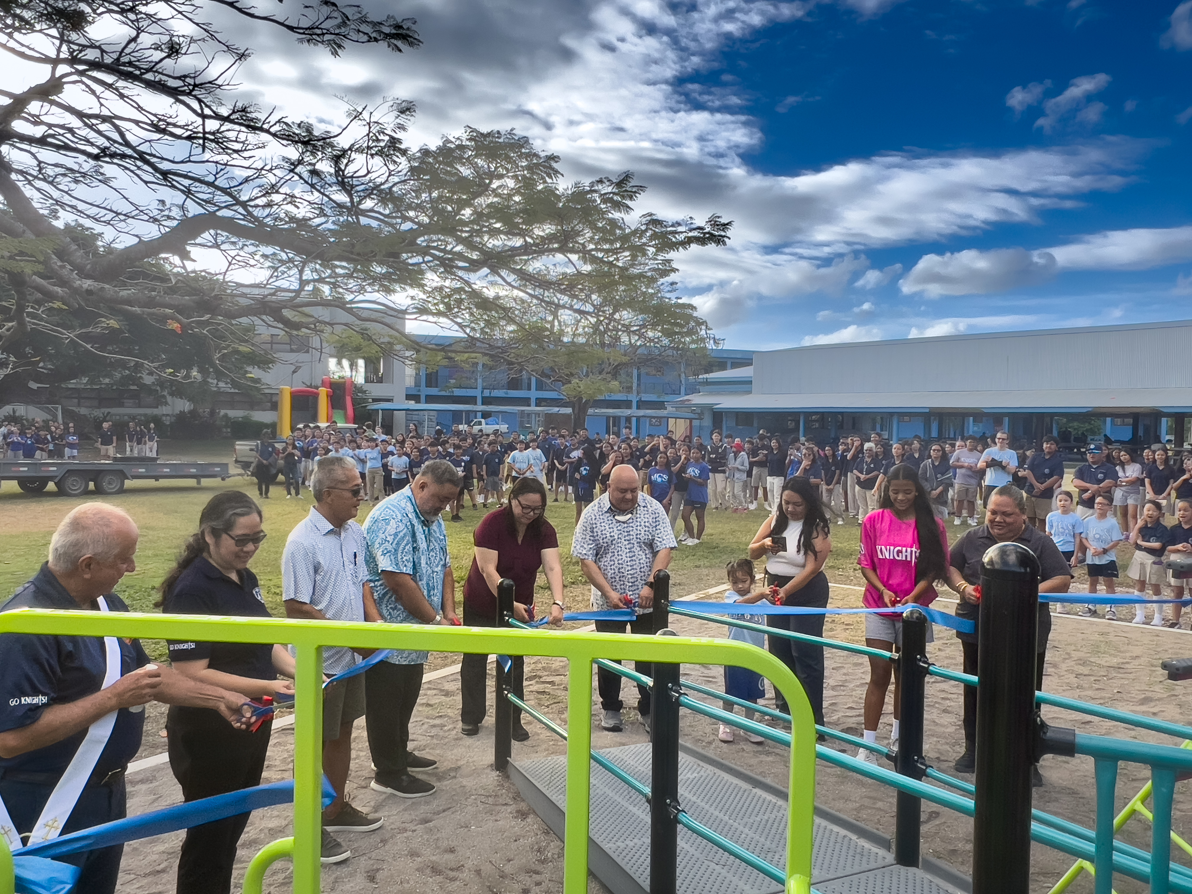 While Mount Carmel School students look on, MCS President John Blanco, Commissioner of Education Dr. Lawrence F. Camacho, MCS President Emerita Frances Taimanao, MCS Principal Filmah Beunaflor, Deacon Rosiky Camacho, MCS Board Vice Chair Crystal C. Deleon Guerrero, contractor Gabriel Boyer and student leaders cut the ceremonial ribbon of MCS’ new, federally funded playground on Friday.PSS photo 