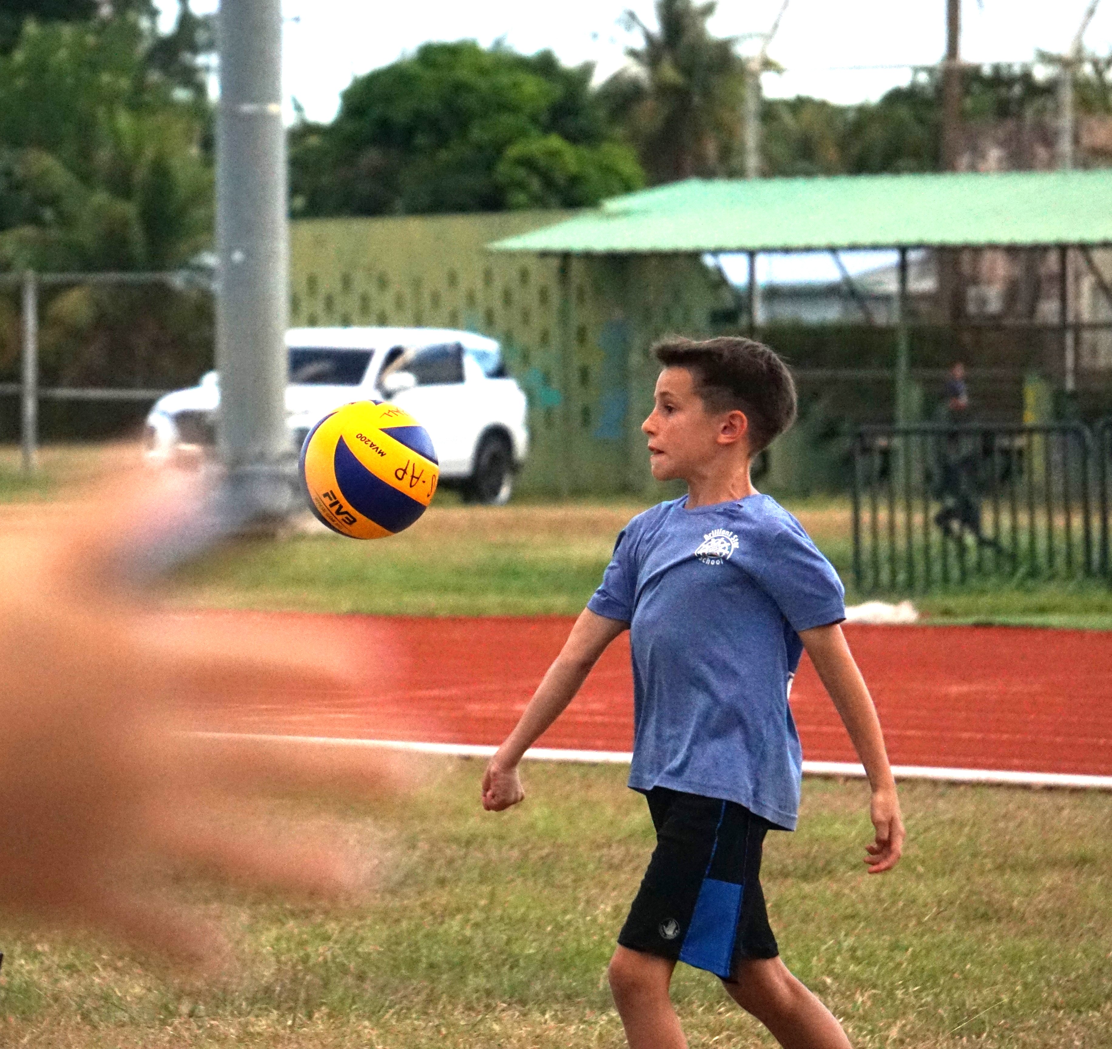 A Brilliant Star School student attempts an underhand serve during a co-ed elementary school division game of the PSS-NMIVA Interscholastic Volleyball League SY24-25 at the Oleai Sports Complex on Friday.