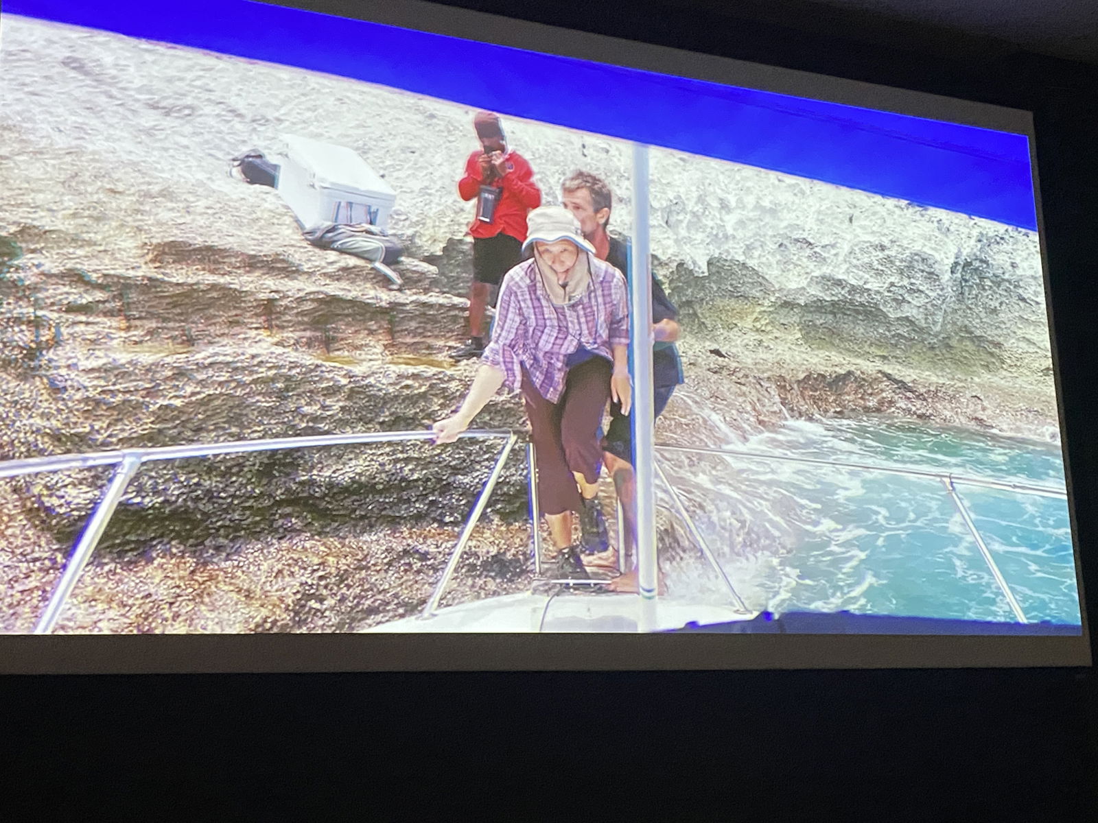 A scene from the documentary shows Dr. Andrea Jalandoni departing Aguiguan by jumping off it and onto a boat.