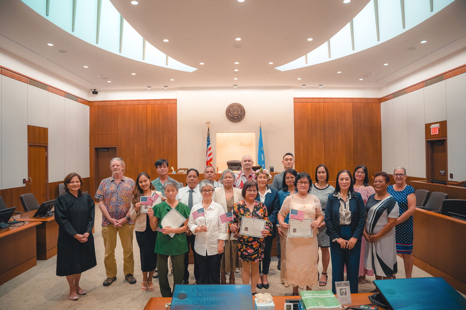 The 17 new U.S. citizens pose for a photo with District Court for the NMI Chief Judge Ramona V. Manglona, USCIS Officer Patricia Phelan and the keynote speaker, Dr. Chas Algaier of Marianas High School in the federal courtroom on Tuesday, Feb. 18, 2025.District Court for the NMI photo