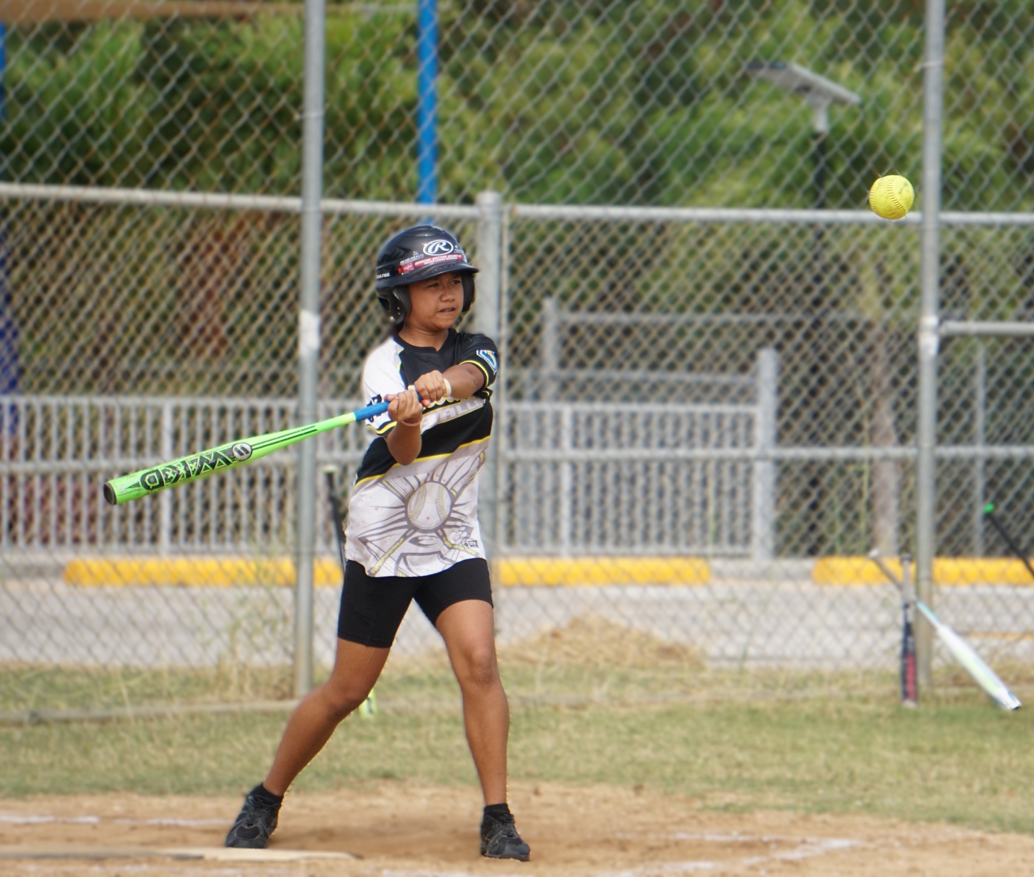 A Tanapag Middle School player swings at the ball during a girls middle school division game of the PSS-NMISA Interscholastic Fastpitch Softball League SY24-25 at the Dandan softball field.   