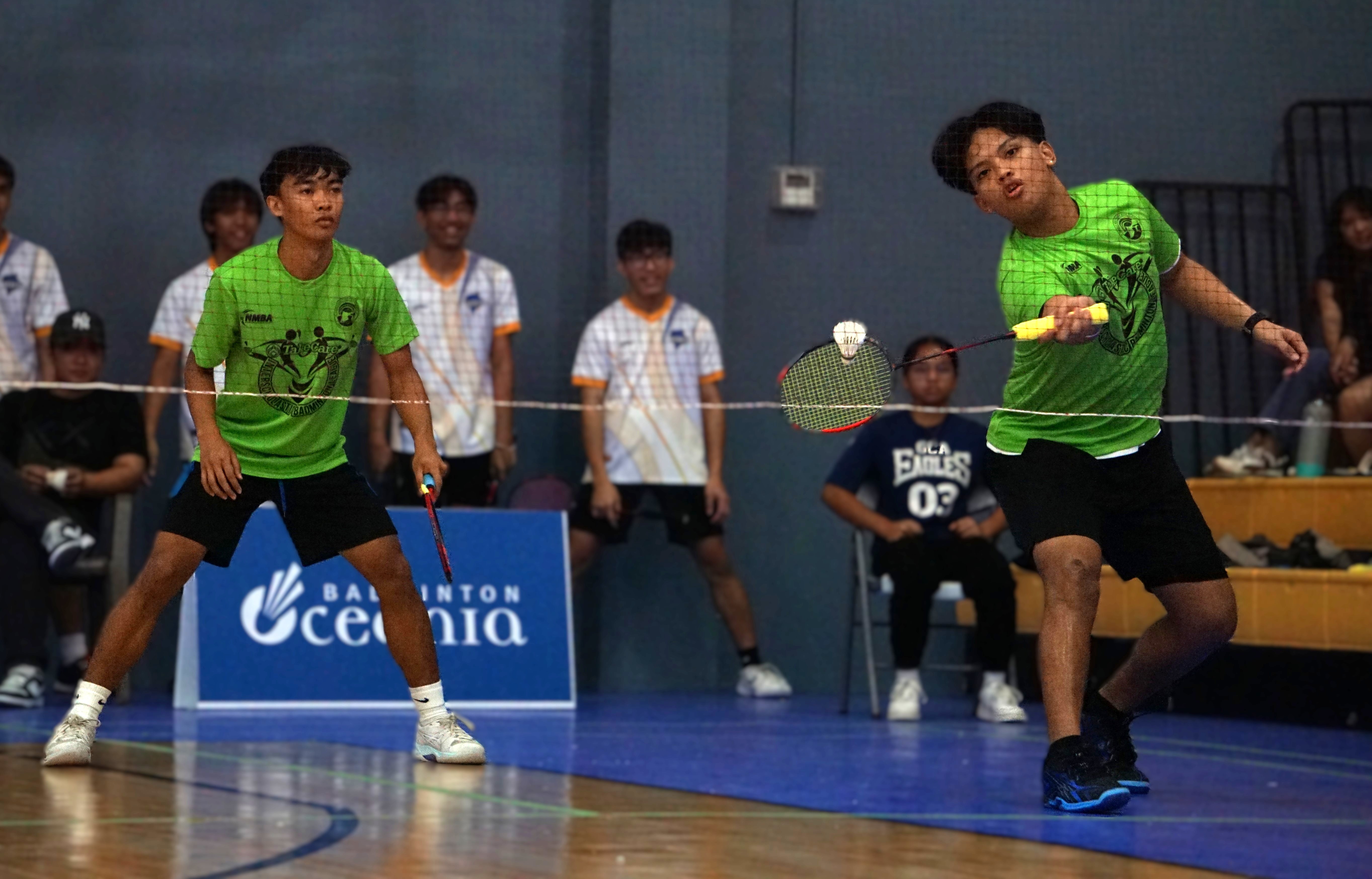 A Saipan Southern High School player extends for the front-hand return alongside his teammate during a boys doubles match in the co-ed high school division of the PSS-NMBA Interscholastic Badminton League SY24-25 at the Ada gym.Photo by James F. Sablan Jr.