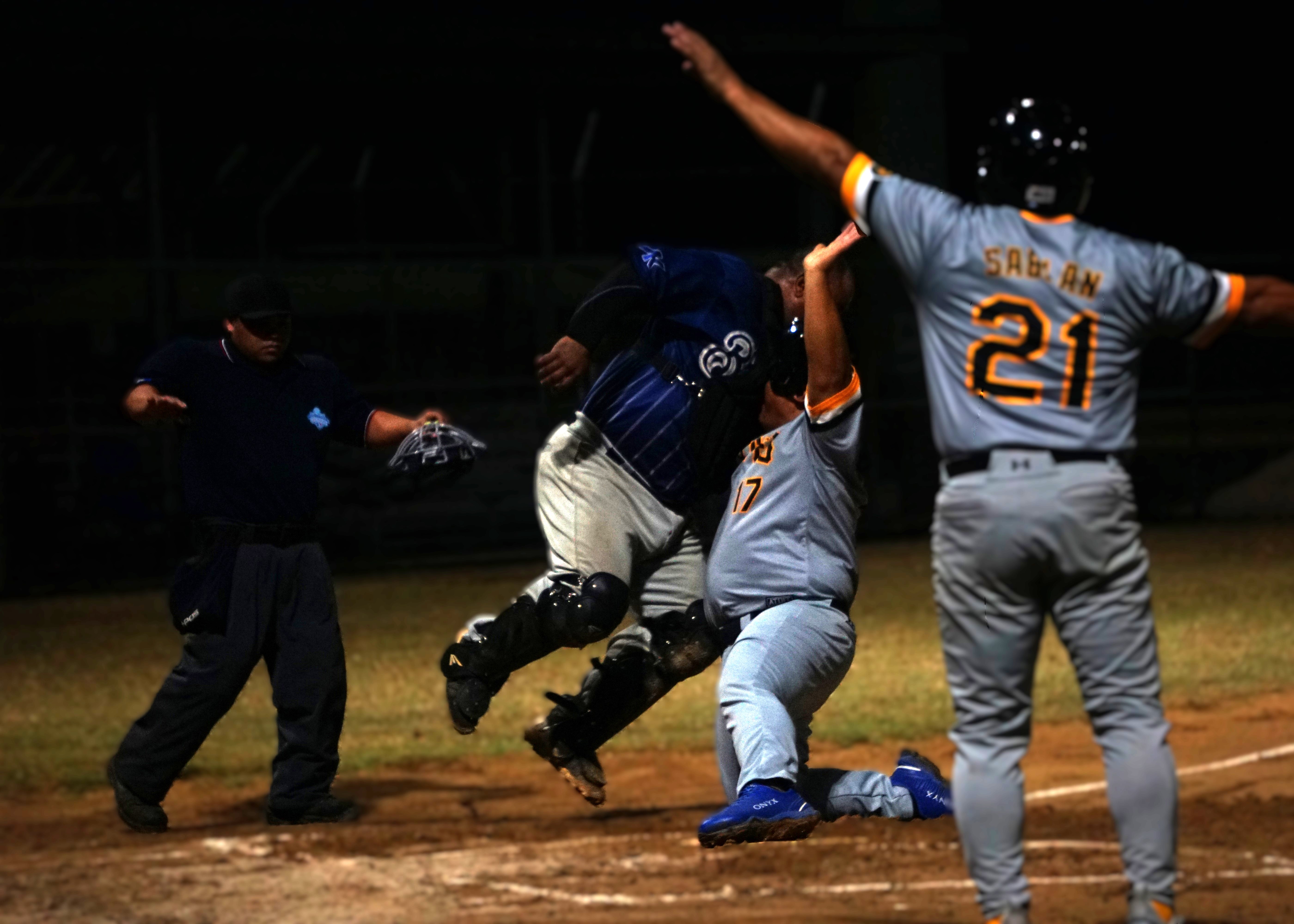 The umpire signals “safe” as Pirates’ Joey Dela Cruz makes contact while sliding into home plate for a scored run against the Brewers in game 1 of the SBL Masters League Championship Series at the Francisco “Tan Ko” Palacios Baseball Field on Monday night.Photo by James F. Sablan Jr.