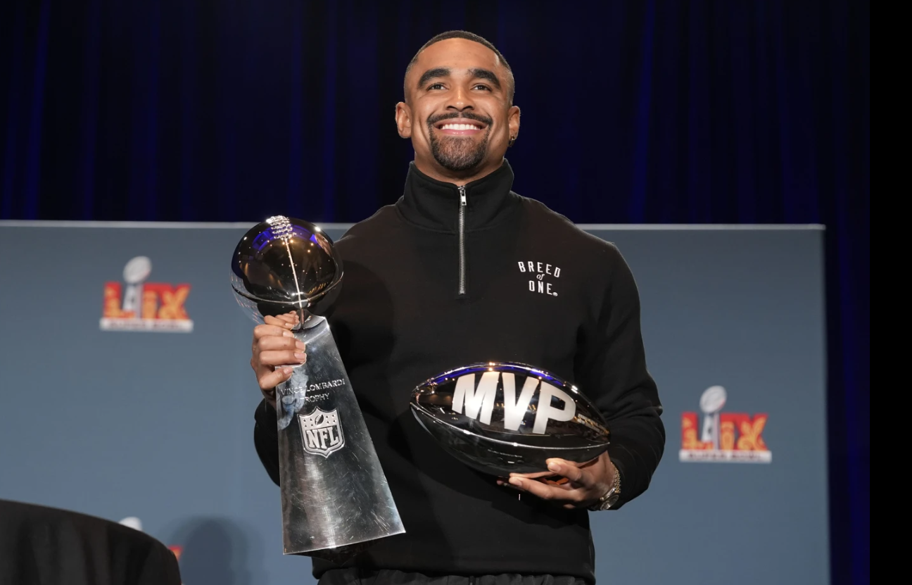 Philadelphia Eagles quarterback Jalen Hurts poses with the Vince Lombardi Super Bowl trophy and the Pete Rozelle MVP trophy during a news conference the morning after the NFL Super Bowl game between the Eagles and the Kansas City Chiefs, Monday, Feb. 10, 2025 in New Orleans.