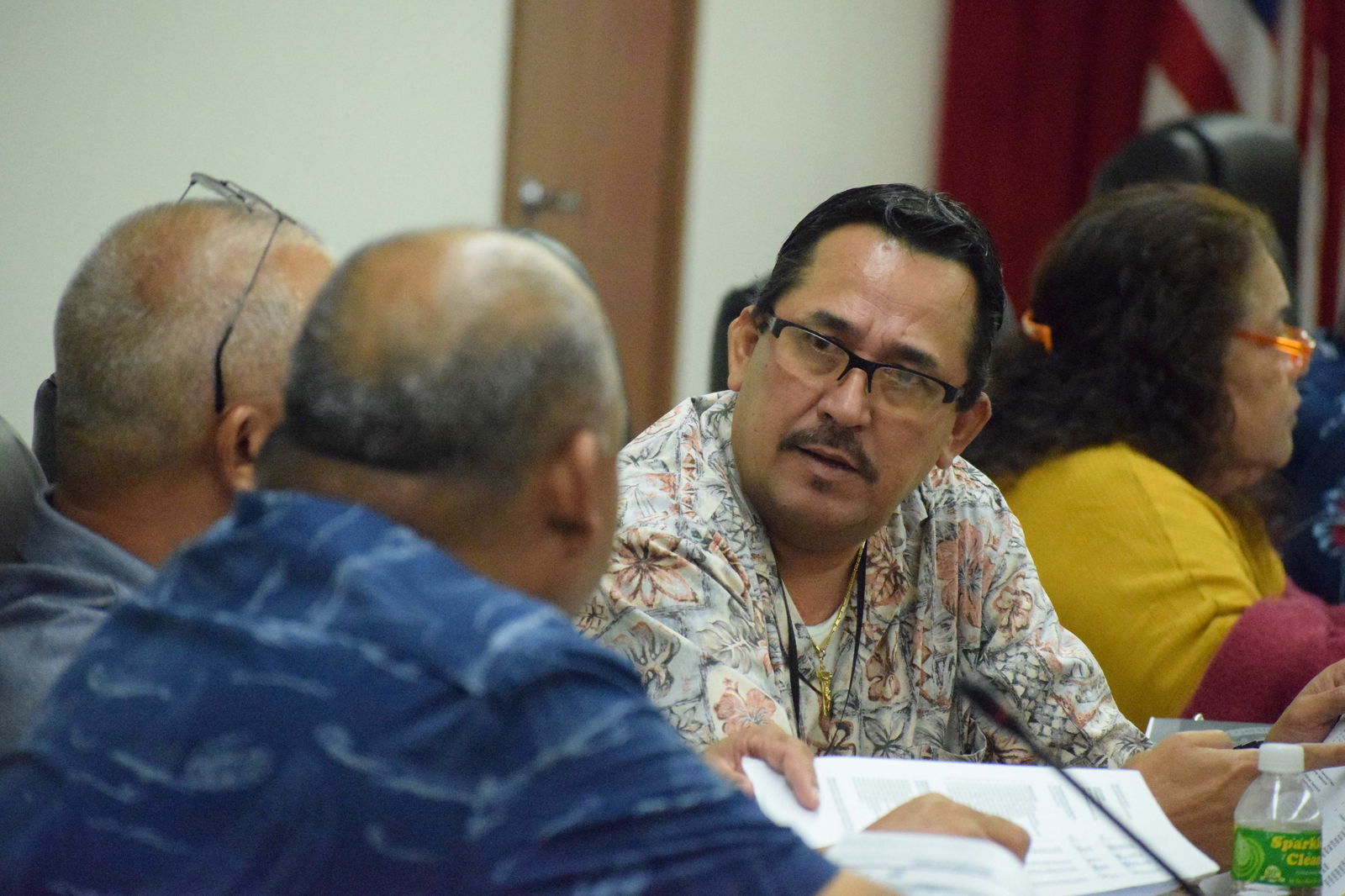 Rep. Patrick San Nicolas confers with Reps. Joseph Flores and John Paul Sablan during a House session in July 2024.