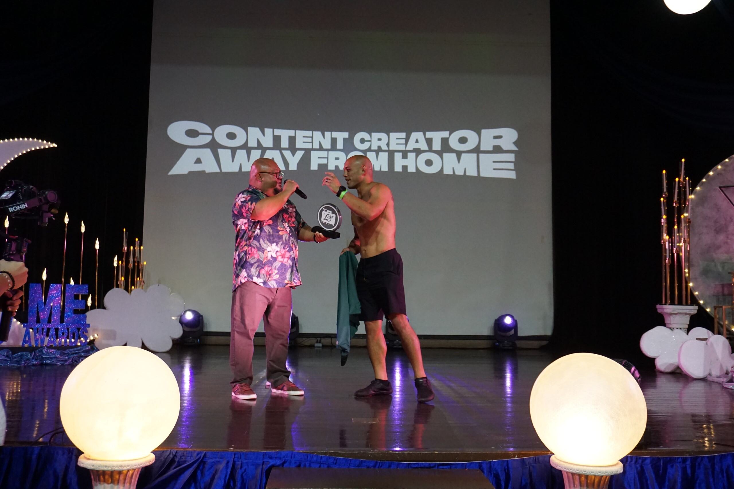 Host Gene Castro, left, with Frank “The Crank” Camacho, the winner of the Content Creator Away from Home Award.