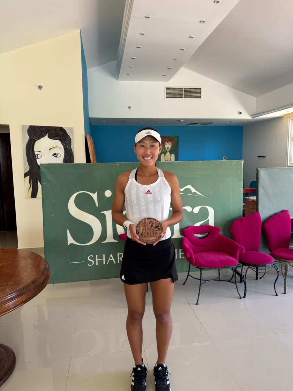 Carol Lee poses with the runner-up trophy in the women's singles event of the Sharm El Shikh Tennis Tournament in Egypt.Contributed photo