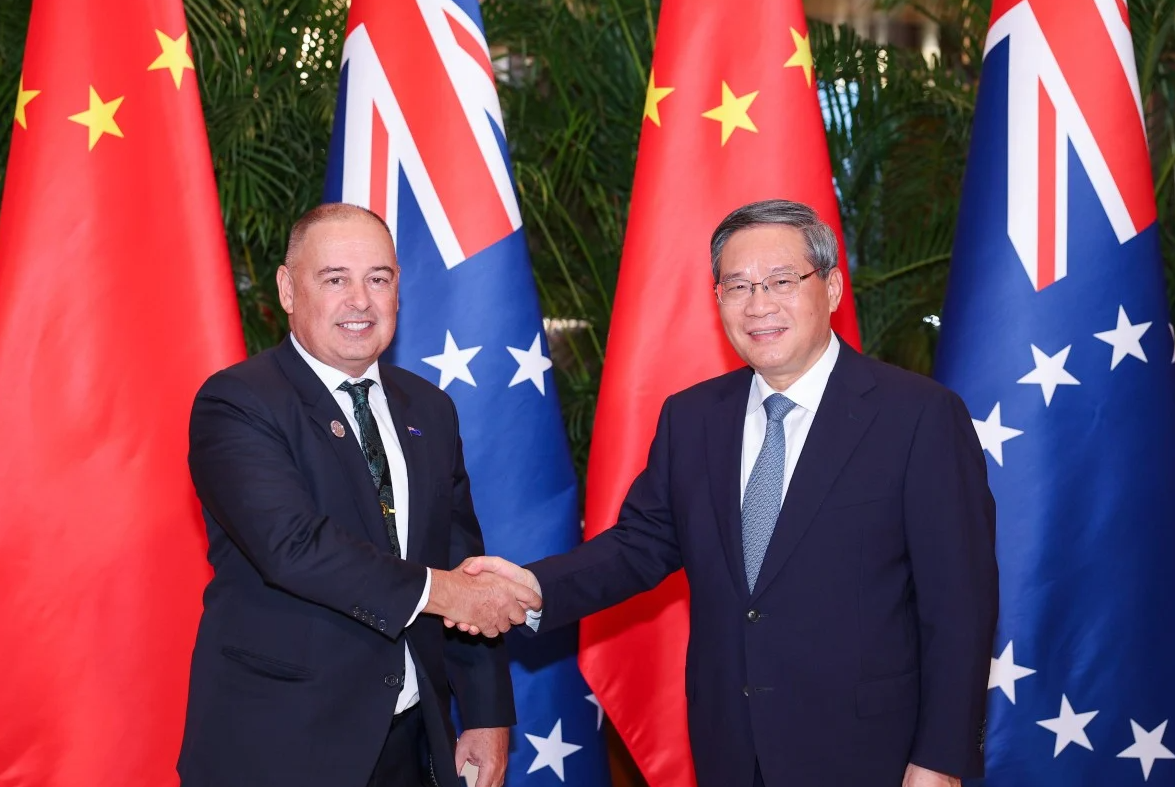 Cook Islands Prime Minister Mark Brown, left, shakes hands with China's Premier Li Qiang.REUTERS