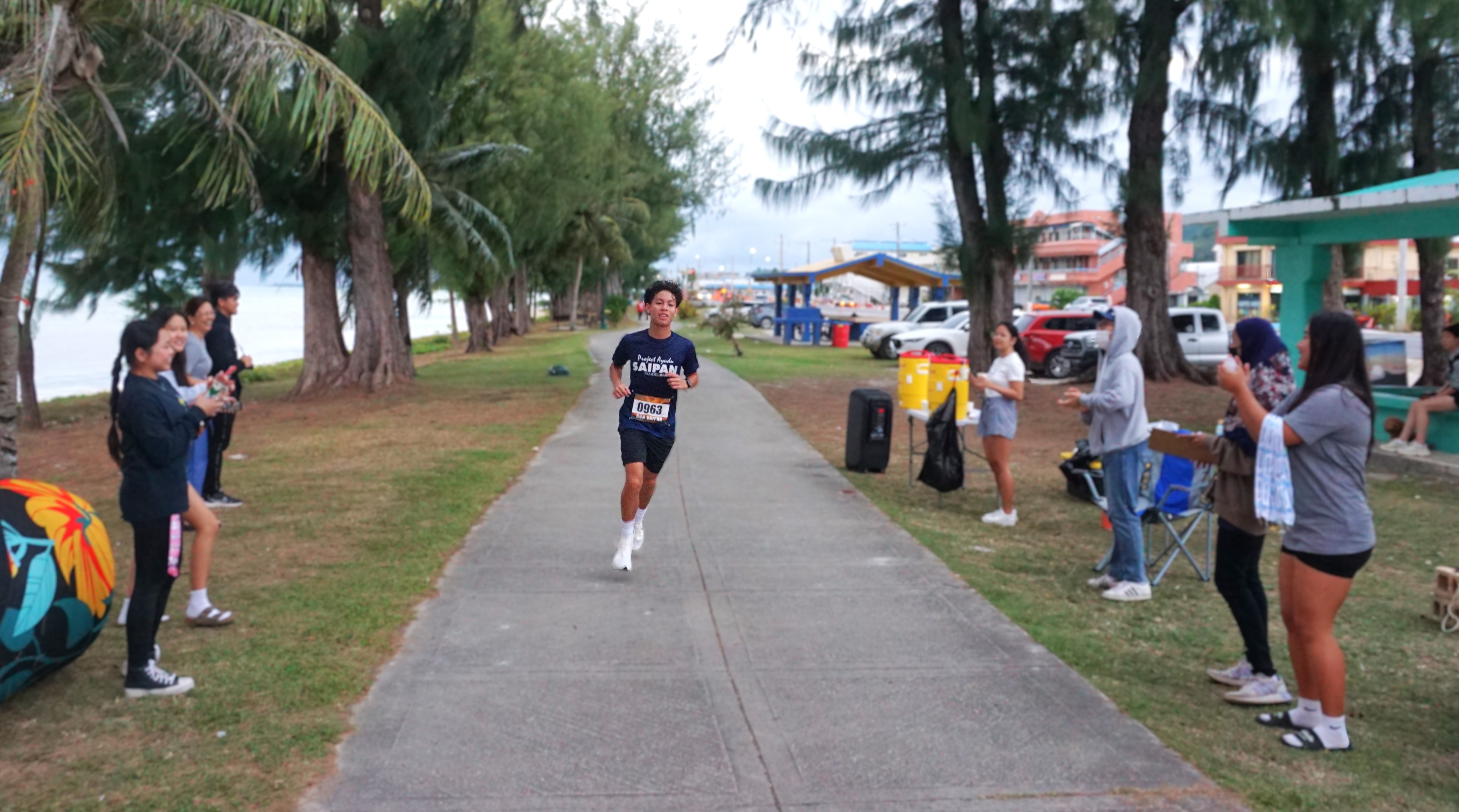 Victor Nash Santos smiles as he finishes first overall in Run Saipan’s Trinity 2025/Beach Path 10K on Saturday.