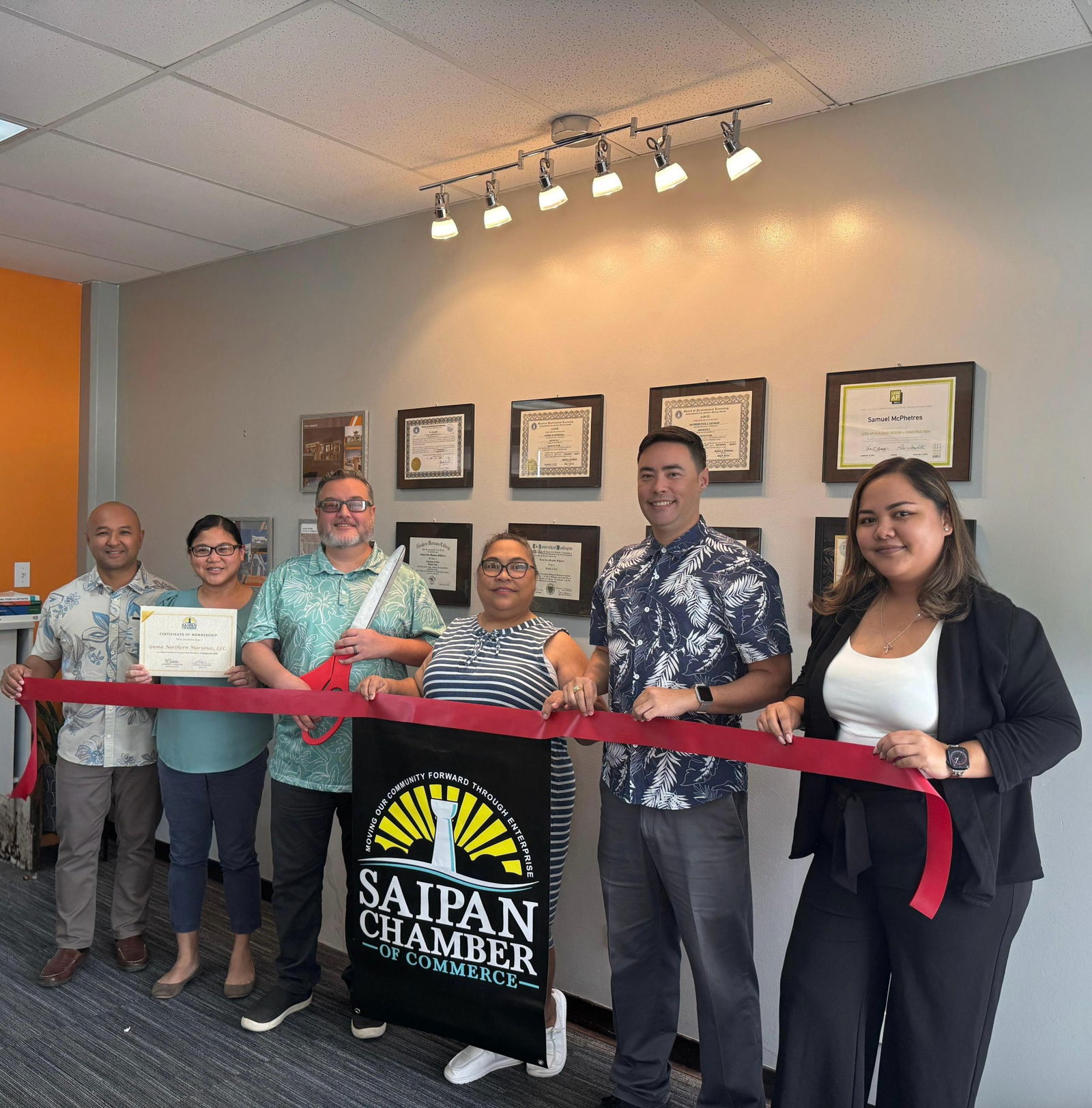 Samuel McPhetres, principal of GUMA Northern Marianas LLC, along with his partner, Janice McPhetres, join the Saipan Chamber of Commerce leadership in ceremonial ribbon-cutting ceremony as a new chamber member.