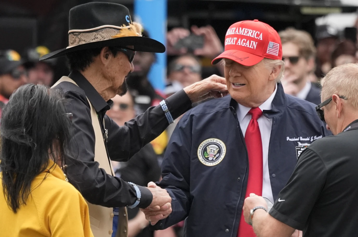 President Donald Trump, right, shakes hands with NASCAR Hall of Fame driver Richard Petty at Daytona International Speedway, Sunday, Feb. 16, 2025 in Daytona Beach, Fla.