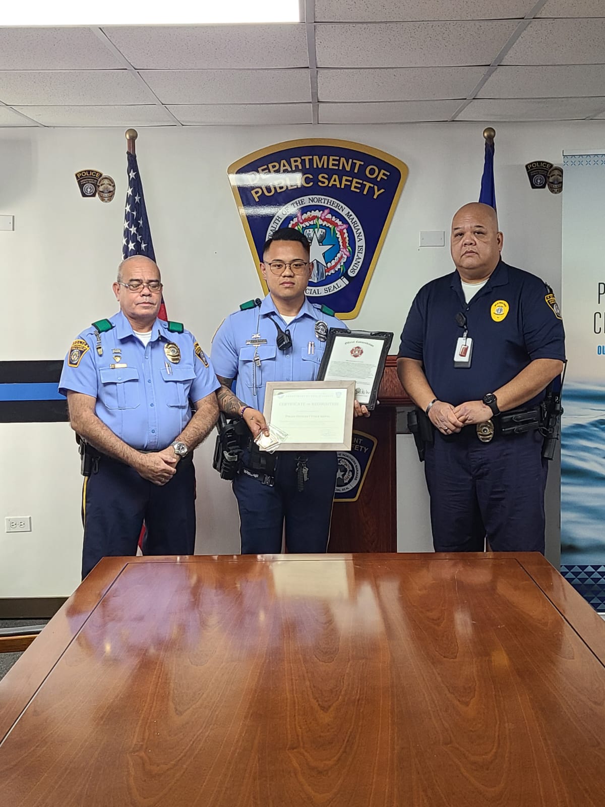 Police Officer Vince Igitol, center.