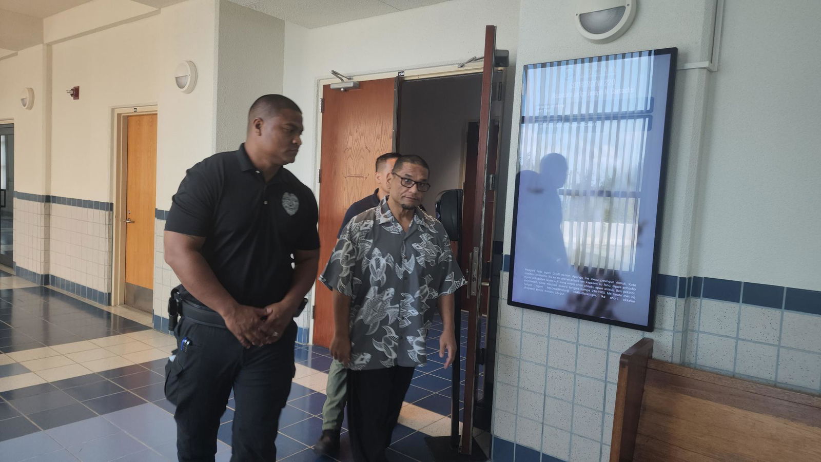 Calvin Tagabuel, right, is escorted by Corrections officers at the local courthouse on Tuesday.
