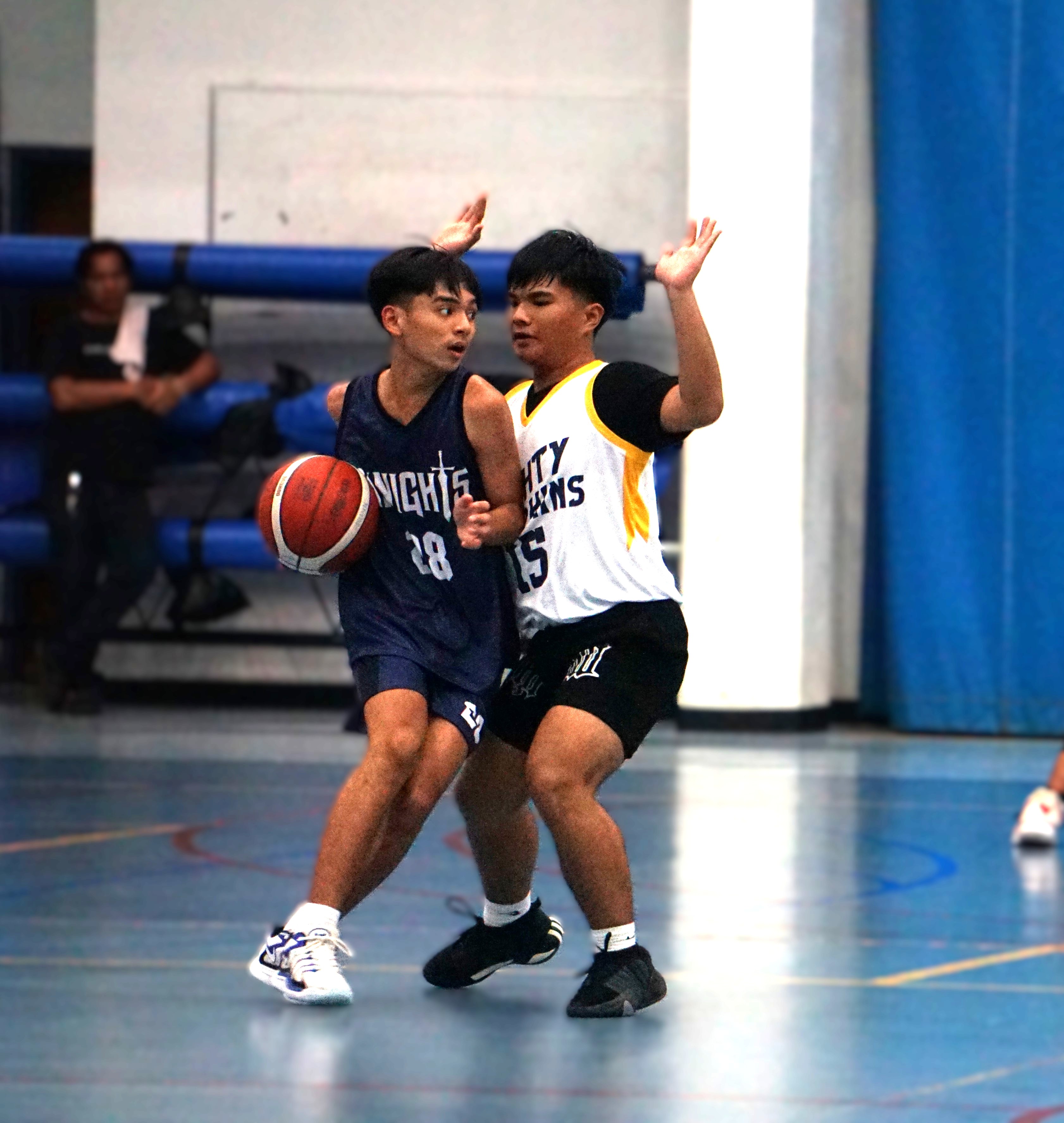 MCS White's Jener Pineda makes contact as he attempts to dribble past MHS Yellow's Hilario Palino during a boys high school division game of the PSS-NMIBF Interscholastic Basketball League SY24-25 at the Marianas High School gym on Wednesday.