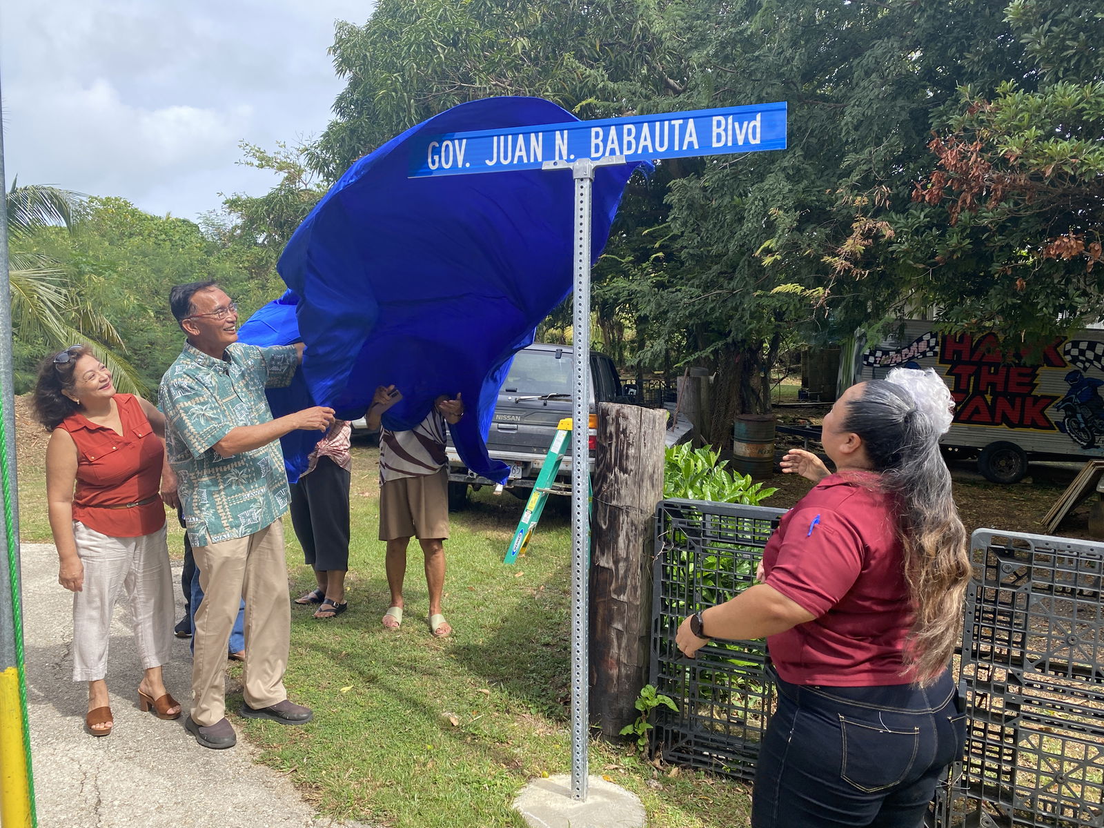 With his wife Charlene T. Babauta, former Gov. Juan N. Babauta unveils a road sign that bears his name in a ceremony organized by the Mayor’s Office of Saipan on Thursday.