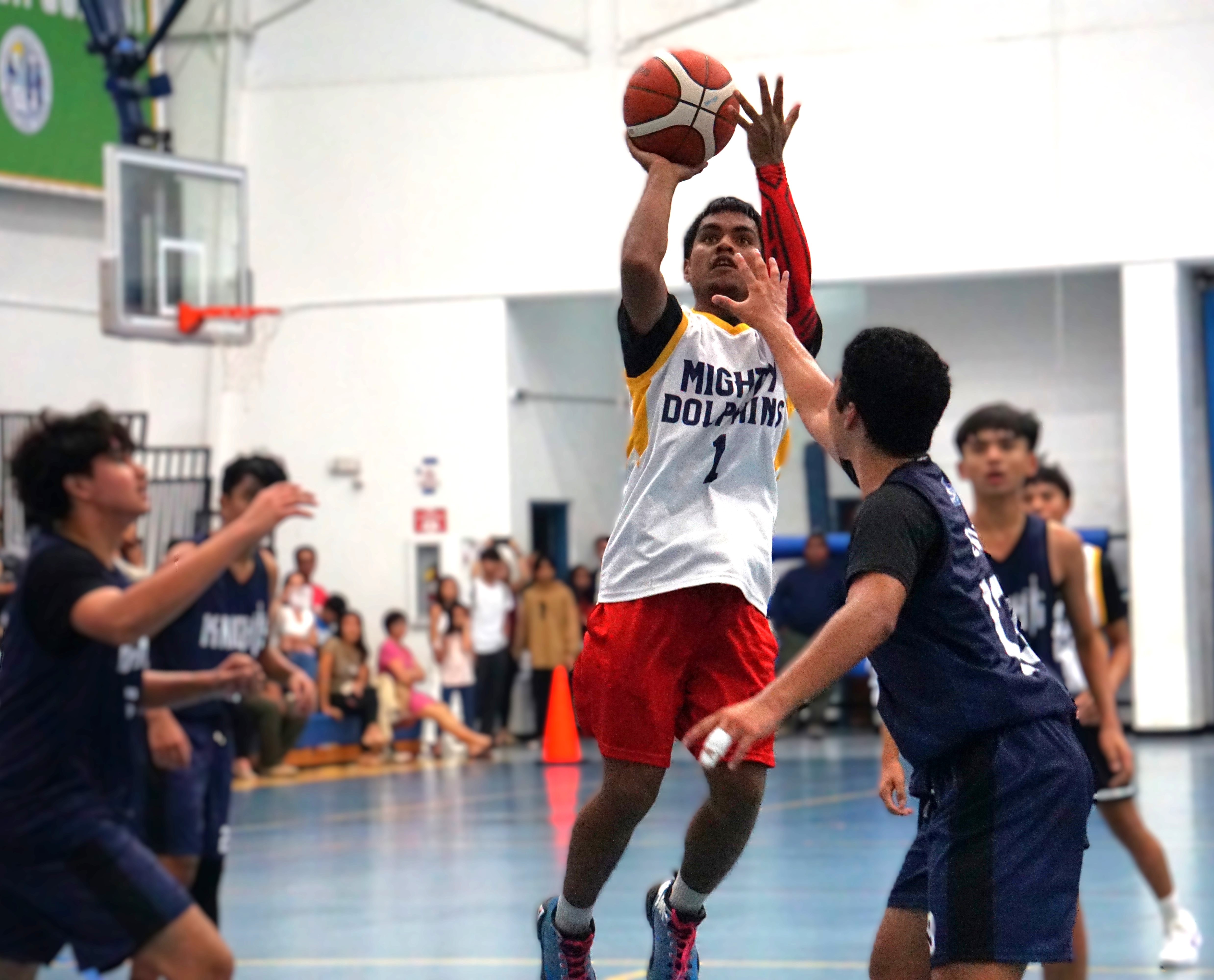 MHS Yellow's Nigel Kochi pulls up for the mid-range jumper while surrounded by four MCS White defenders during a boys high school division game of the PSS-NMIBF Interscholastic Basketball League SY24-25 at the Marianas High School gym on Wednesday.