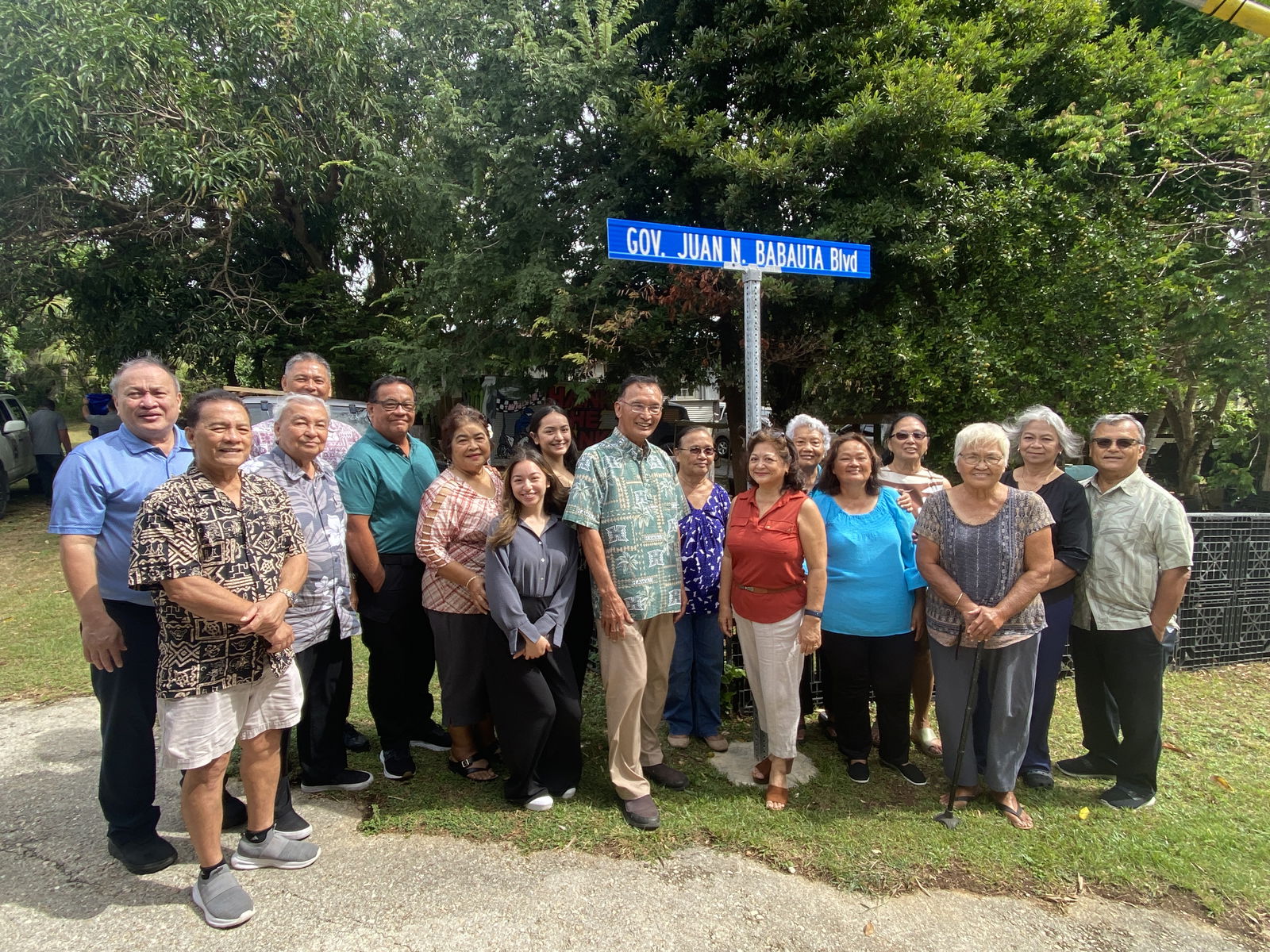 Former Gov. Juan N. Babauta and his wife Charlene pose with Saipan Mayor RB Camacho, family members and friends near the road sign that bears the former governor’s name