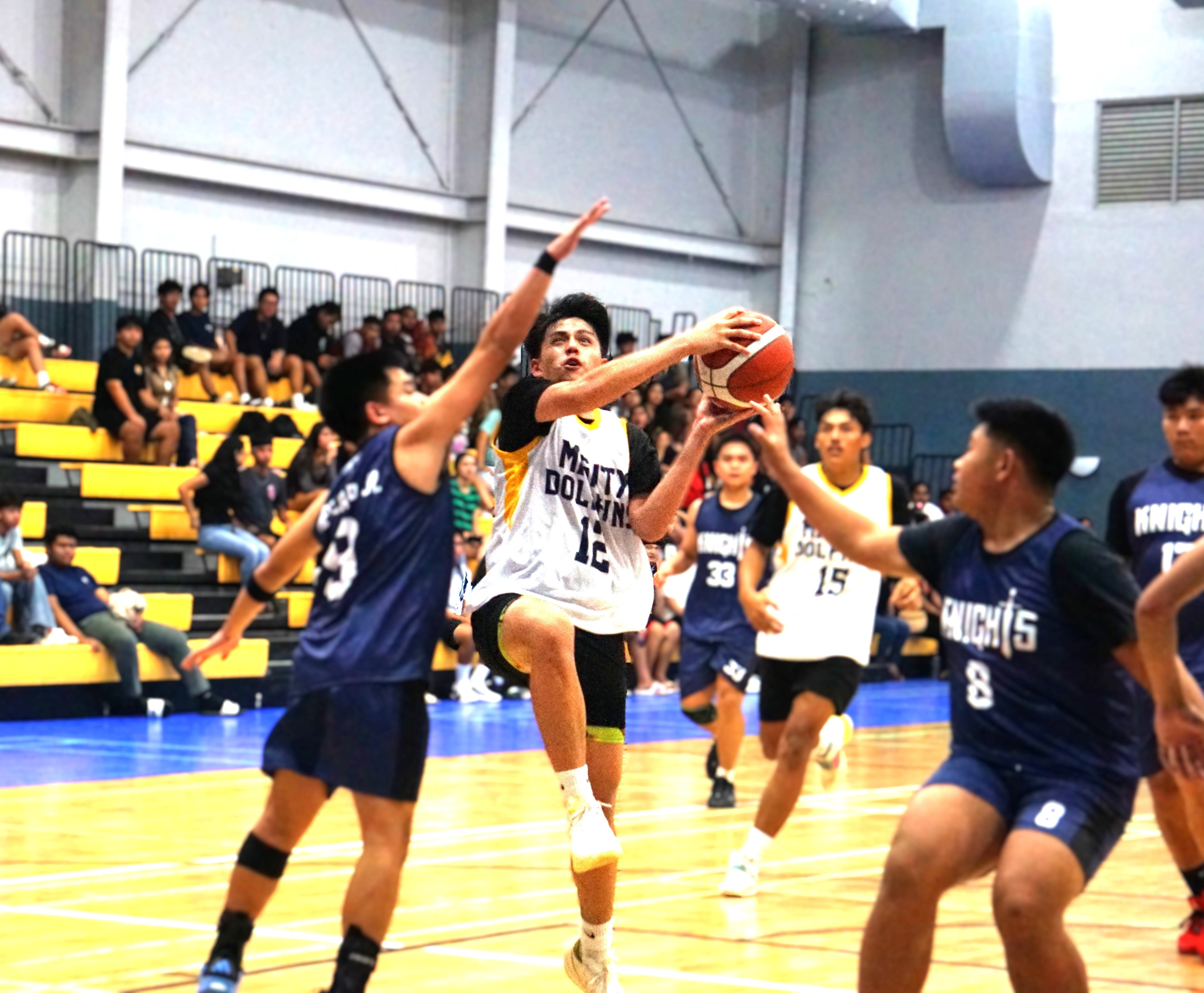 MHS’ Marc Tengco attempts a drive between two defenders during an opening game against MCS in the boys high school division of the PSS-NMIBF Interscholastic Basketball League SY24-25 at the Gilbert C. Ada Gymnasium on Friday.