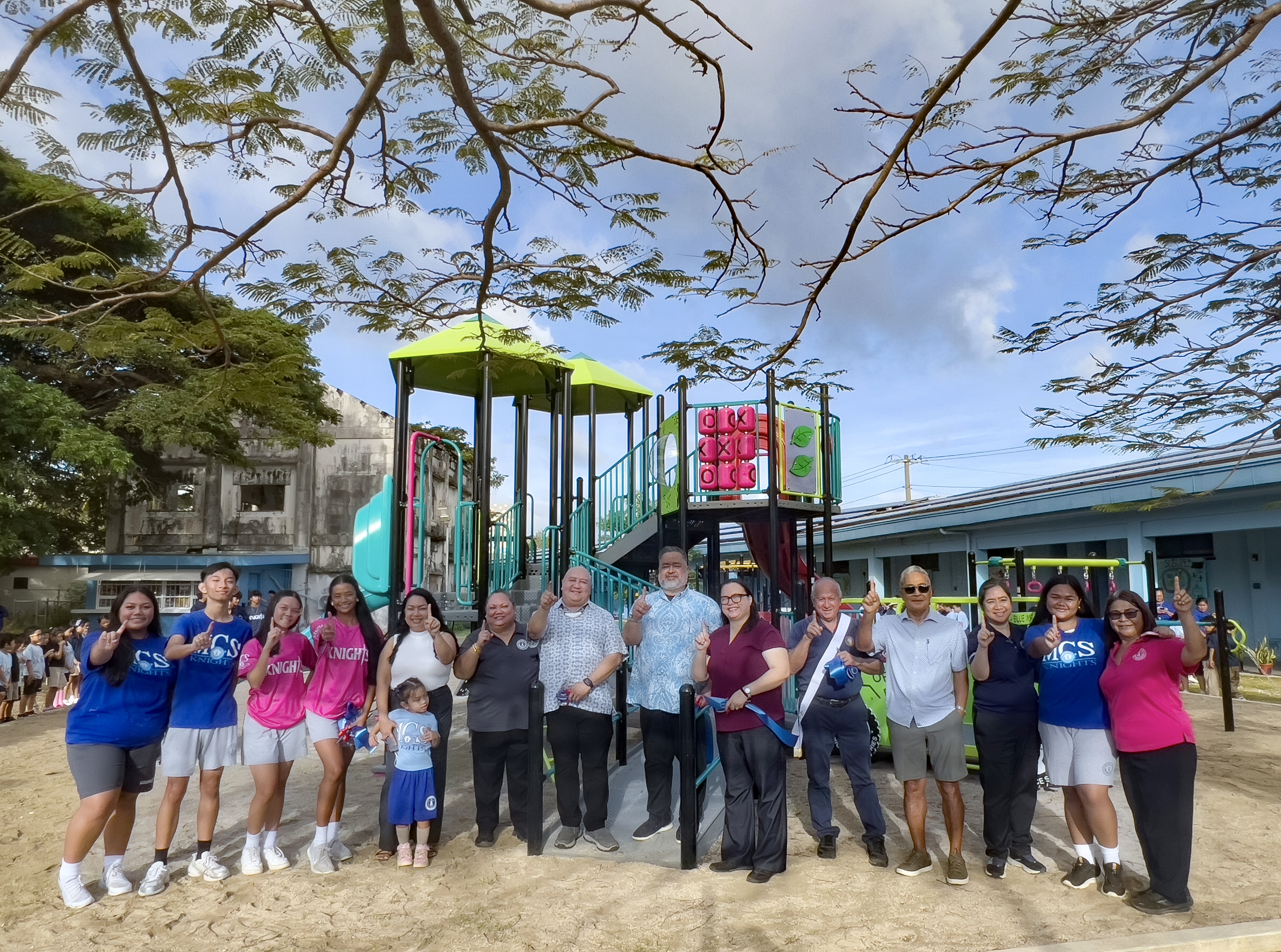 Public School System Commissioner of Education Dr. Lawrence F. Camacho poses for a photo with Mount Carmel School President John Blanco, MCS President Emerita Frances Taimanao, PSS Federal Program’s Office State Program Office for Equitable Services & Co-Ombudsman Melisha San Nicholas, MCS Vice Chair Crystal C. Deleon and students near the newly inaugurated playground at MCS.