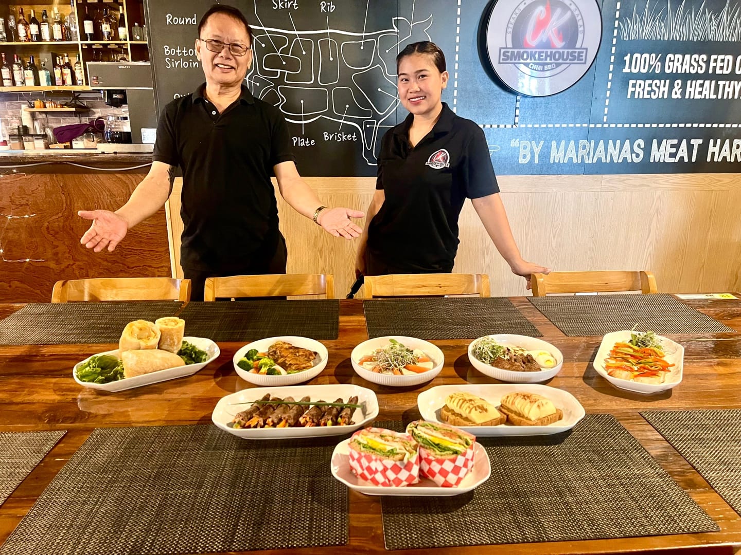 CK Smokehouse Restaurant chefs Fernando Molina and Jorgie Villas pose next to their new menu items.