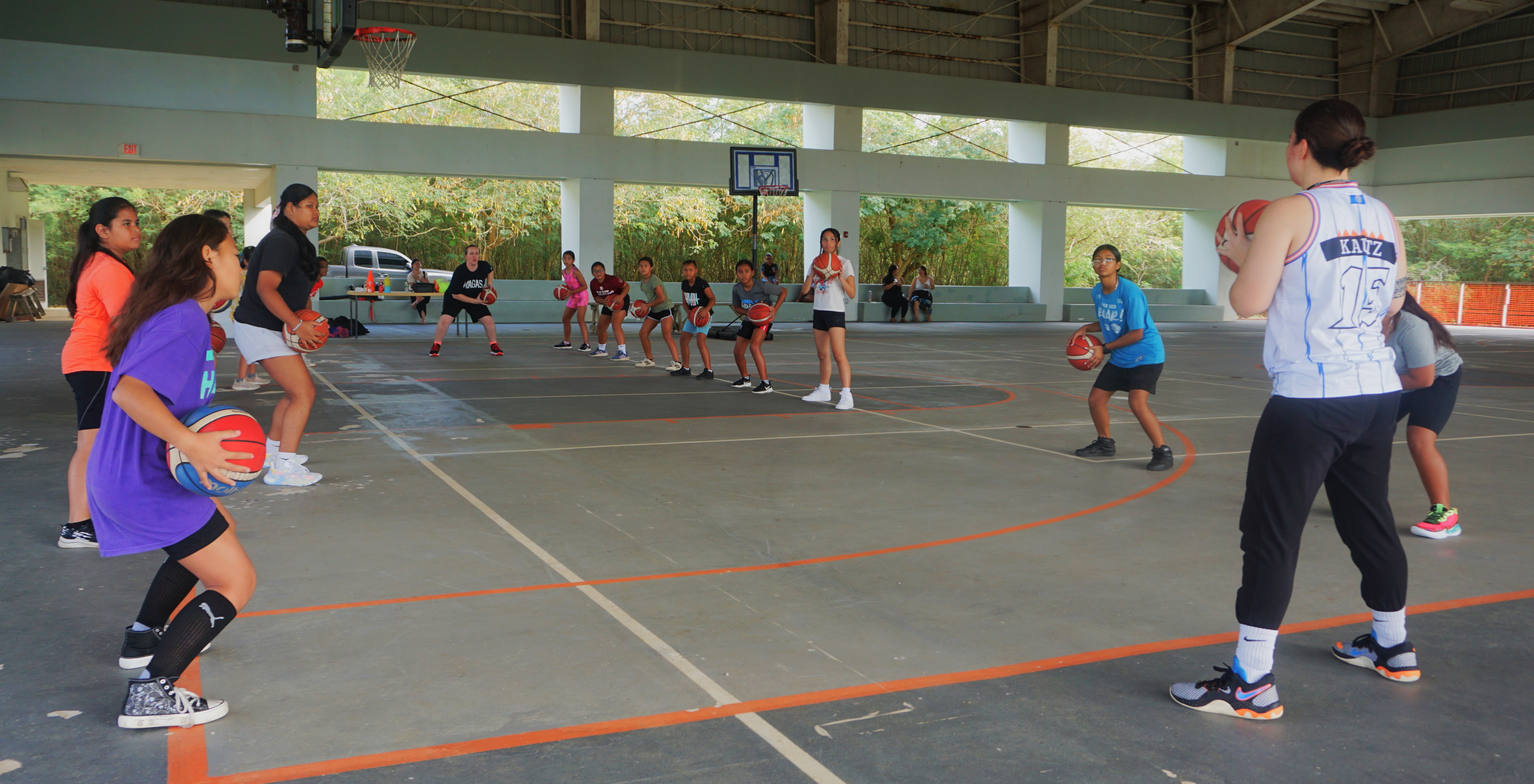 Coach Mikki Kautz leads a dribbling drill during the I Am Her basketball camp at the Koblerville gym on Saturday.