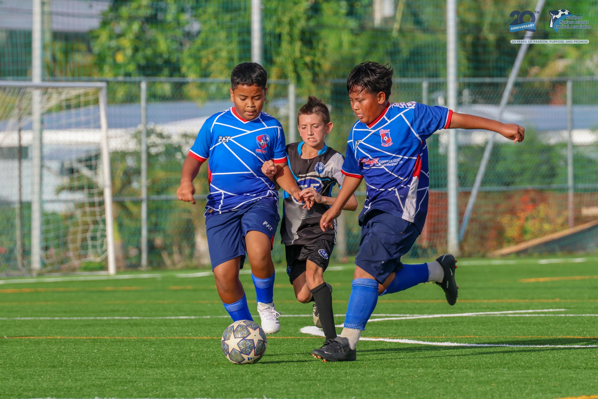 MP United FC's Beau Bauer attempts to slip between two defenders during a game against Shirley's FC in the U12 boys division of the TakeCare Youth Soccer League Spring 2025 at the NMI Soccer Training Center in Koblerville.NMIFA photo