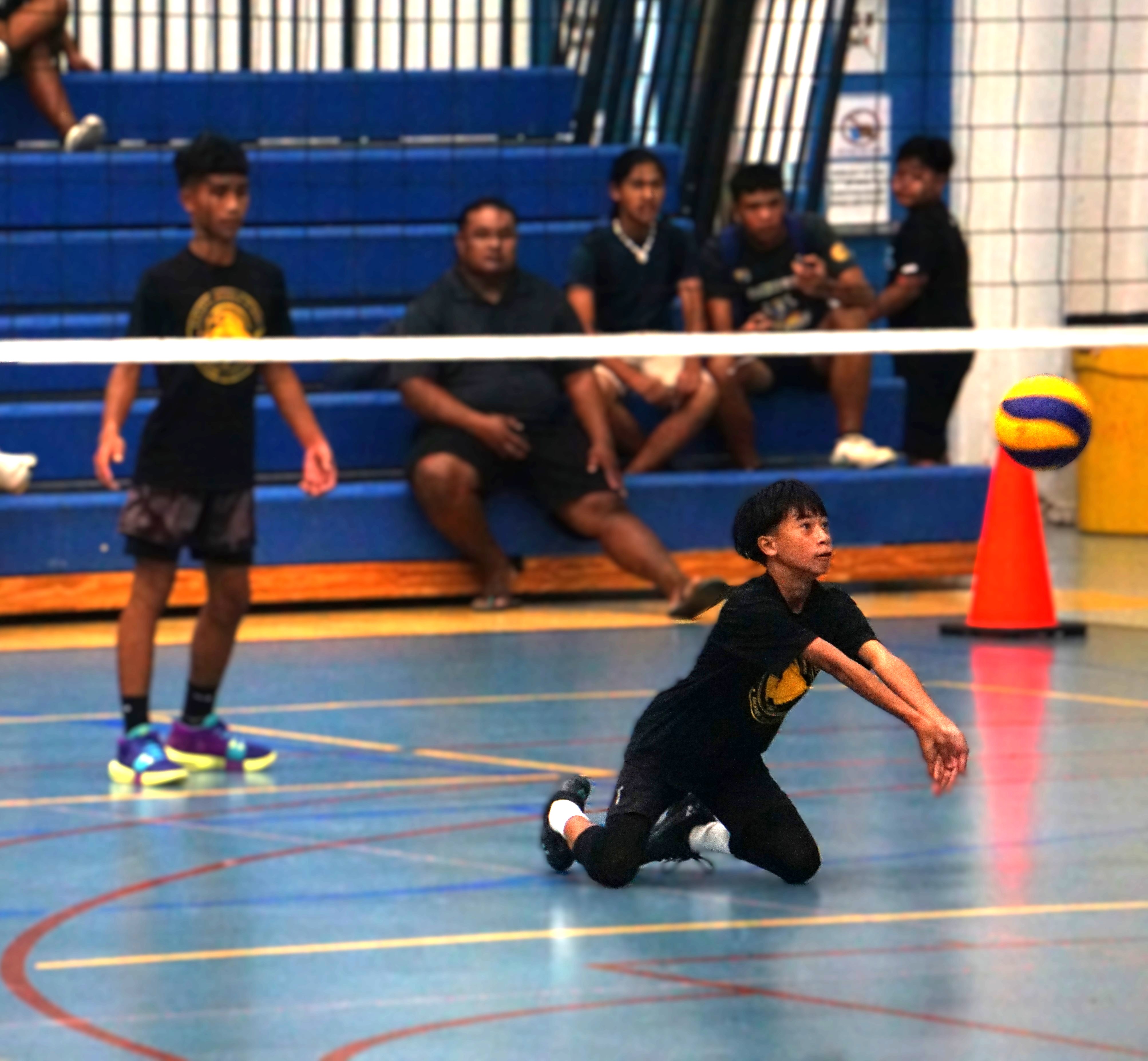 Tanapag Middle School's Rhyane Umali dives to save the possession against Hopwood Middle School during a game in the boys middle school division of the PSS-NMIVA Interscholastic Volleyball League at the Marianas High School gym.