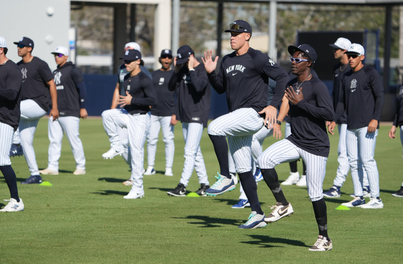 New York Yankees outfielder Aaron Judge (99) and third baseman Jazz Chisolm Jr. (13) warm up during spring training practice at George M. Steinbrenner Field in Tampa, Florida on Feb. 17, 2025.