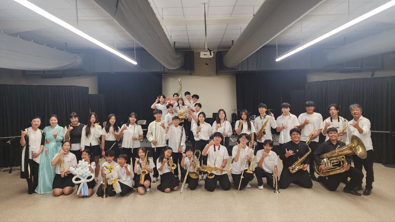 The Saipan Junior Big Band and Korea Junior Big Band pose for a photo after performing at Marianas High School.