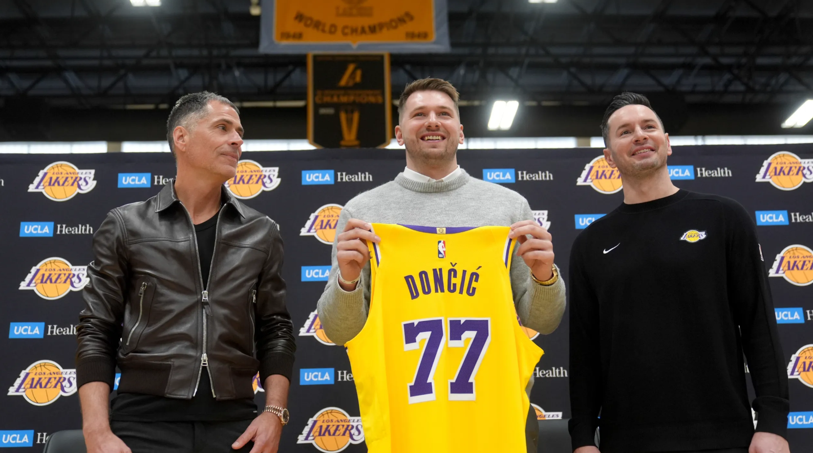 From left, Los Angeles Lakers general manager Rob Pelinka, Luka Doncic, and head coach JJ Redick pose for photos during an introductory NBA basketball press conference Tuesday, Feb. 4, 2025, in El Segundo, Calif.