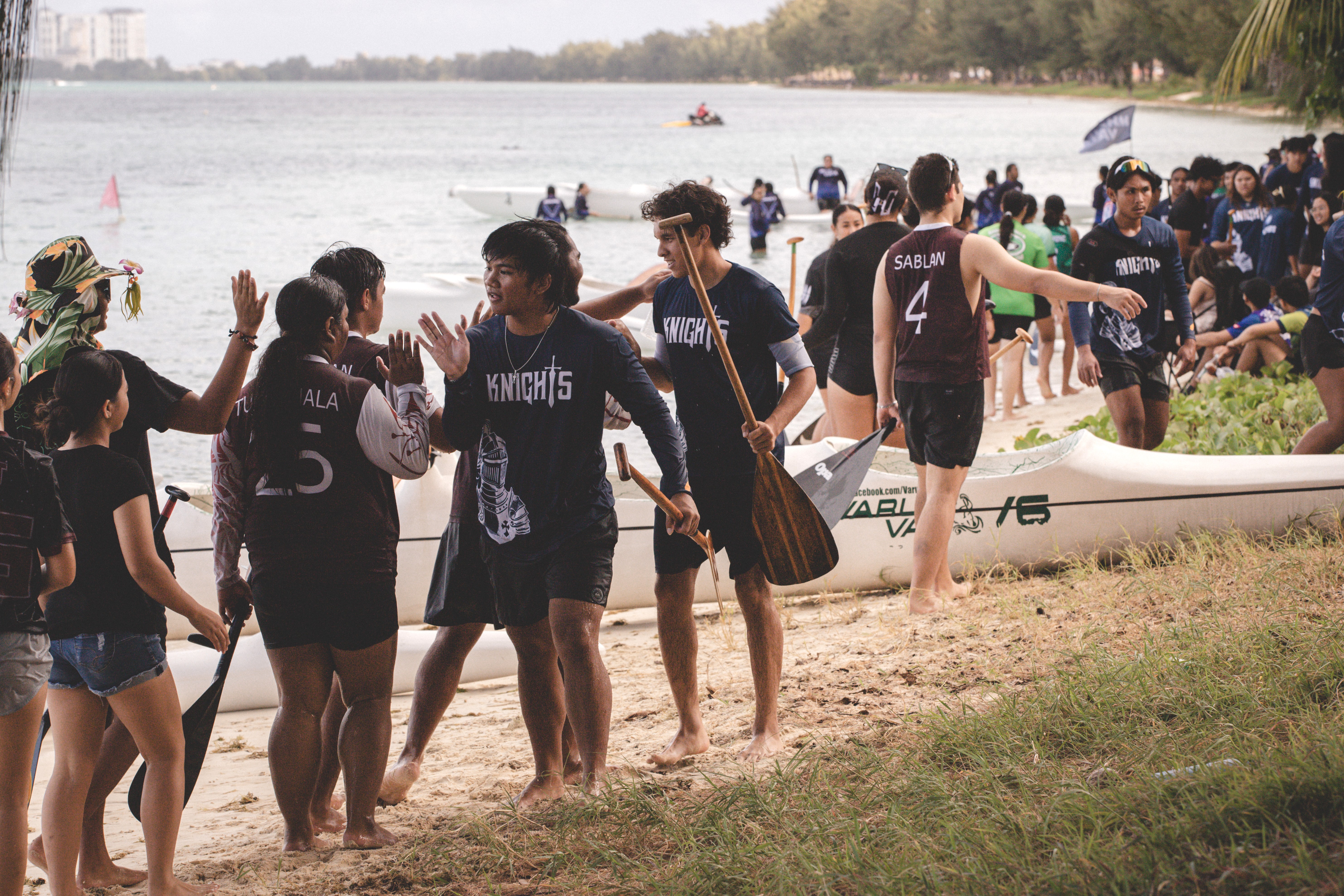 MCS and KHS paddlers high-five each other during the PSS-NMNPSF Interscholastic Outrigger Race Series SY24-25 at Kilili Beach on Saturday.Contributed photo