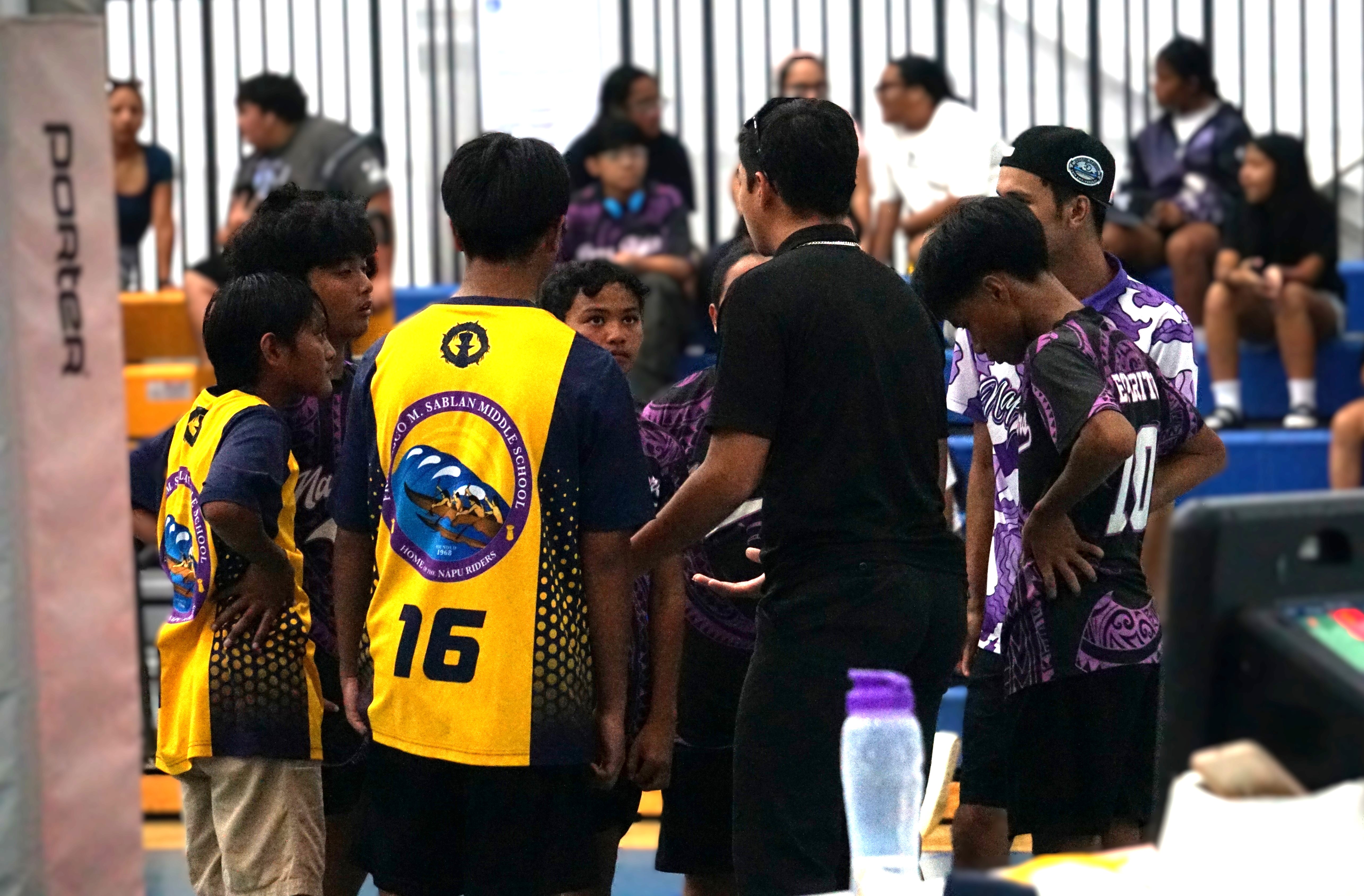 Francisco M. Sablan Middle School players and coach huddle to reassess their strategy during a boys middle school division game of the PSS-NMIVA Interscholastic Volleyball League SY24-25 at the Marianas High School gym.