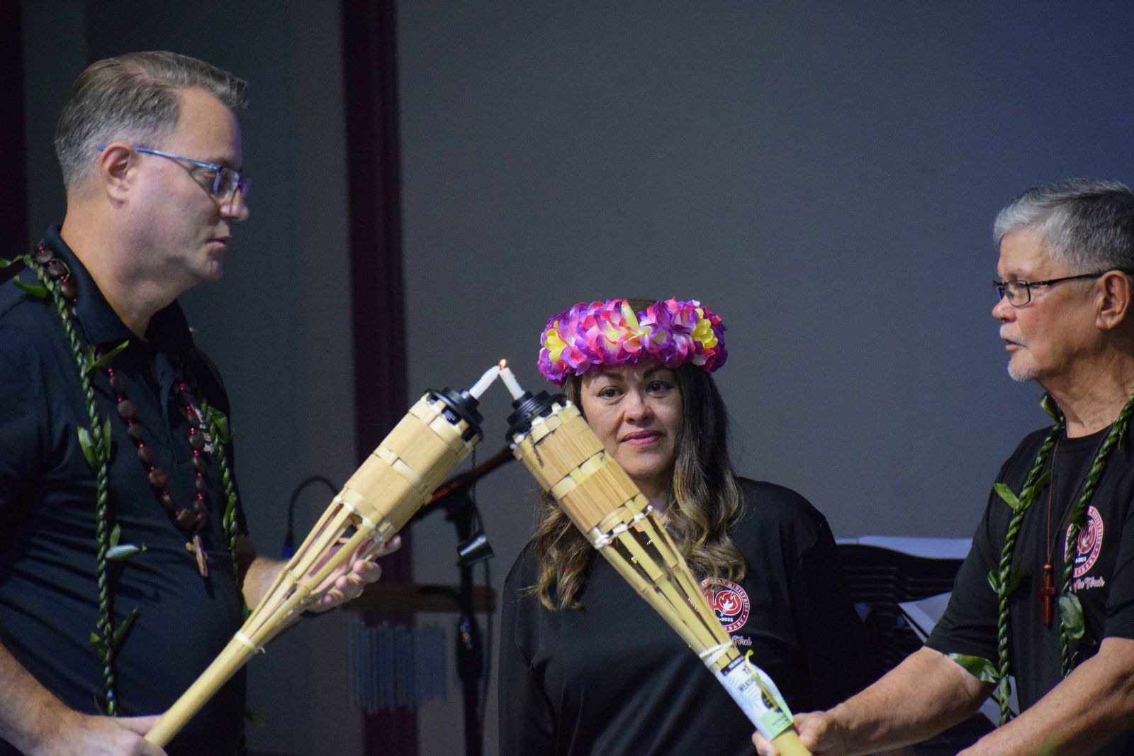 Reverend Raymond Kinsella lights the torch of Senior Pastor Michael D. Rodgers Jr. as his wife, Sister Geri Rodgers, looks on during the Grace Christian Ministries’ 40th anniversary celebration on Feb. 16, 2025 at the GCM Church on Navy Hill.