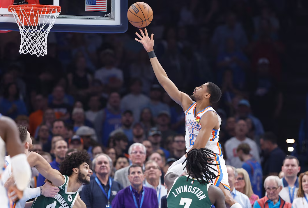 Oklahoma City Thunder guard Aaron Wiggins (21) goes up for a basket against Milwaukee Bucks forward Chris Livingston (7) during the first quarter at Paycom Center in Oklahoma City, Feb. 3, 2025.