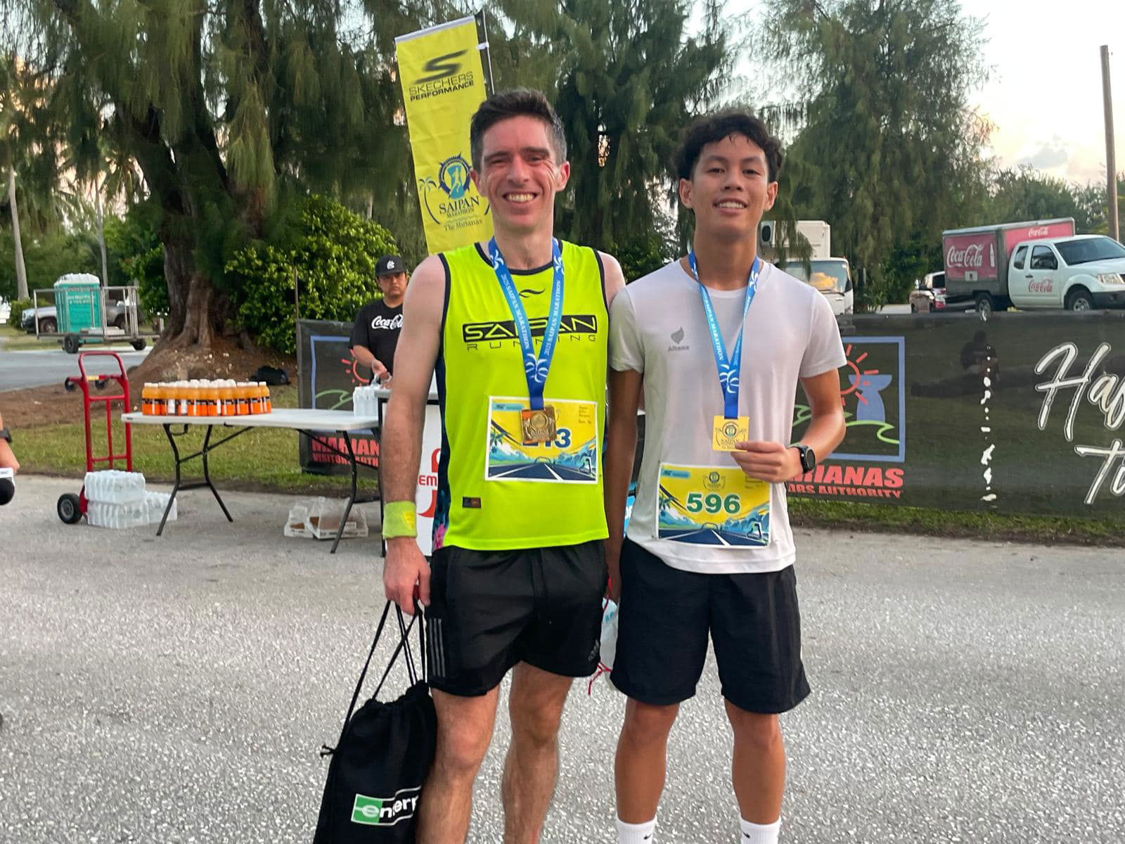 Jody O’Sullivan and Victor Nash Santos pose with their gold (half marathon) and silver (10km) medals after completing the Skechers Saipan Marathon 2025 at Micro Beach on Saturday morning.